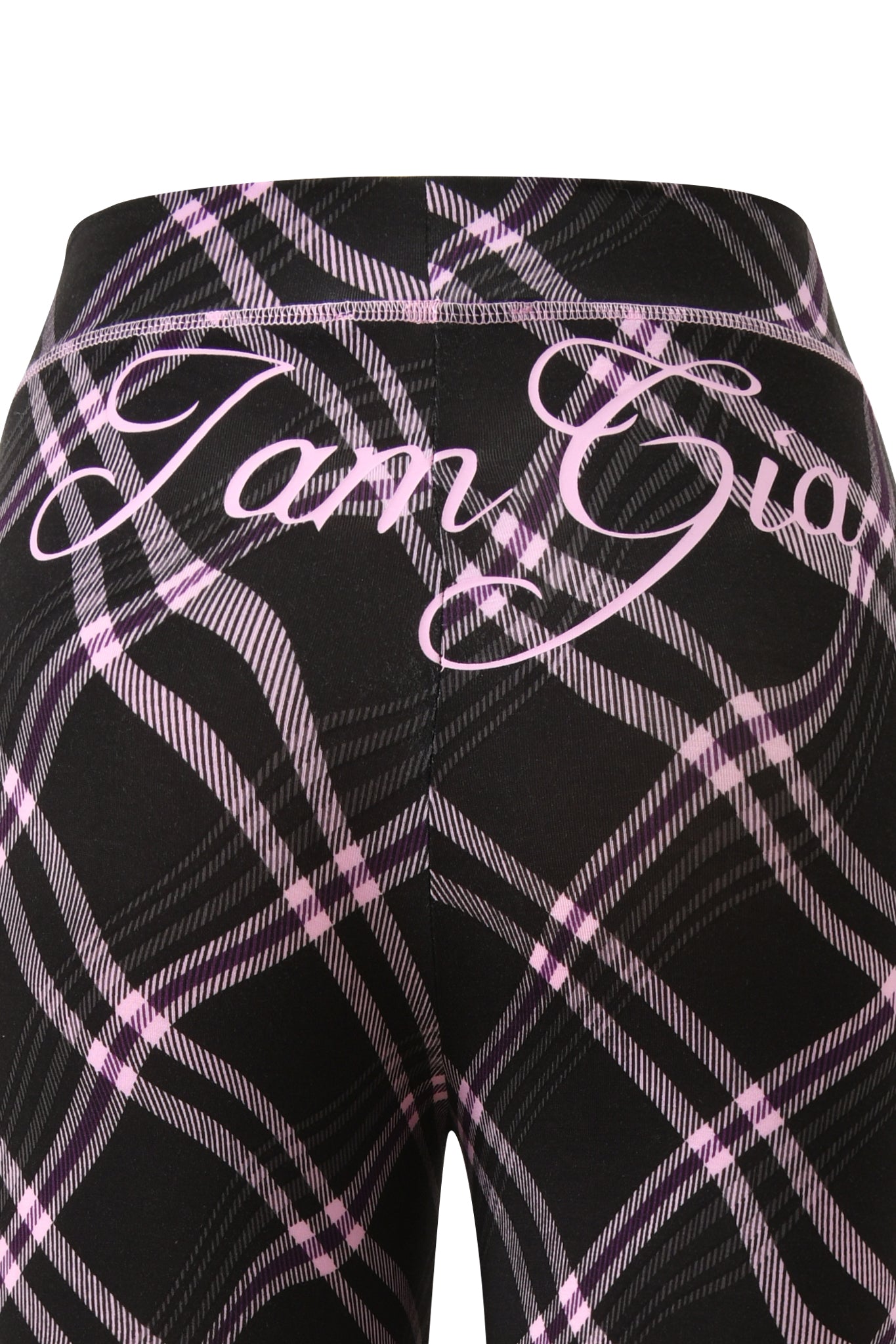Close-up of the BLARE TRACKPANT - BLACK WARPED PLAID by I.AM.GIA, featuring a black plaid with pink and white accents. "I.AM.GIA" is printed in large cursive across the upper back, giving these trackpants a bold, stylish look.