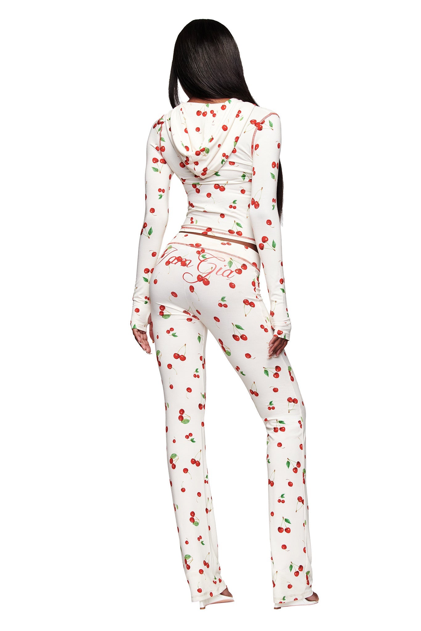 A person with long dark hair wears I.AM.GIA’s BLARE TRACKPANT - CHERRY ON TOP, a white bamboo set with the Cherry on Top print and "Good Girls" in cursive on the back. Shown from behind on a white background.