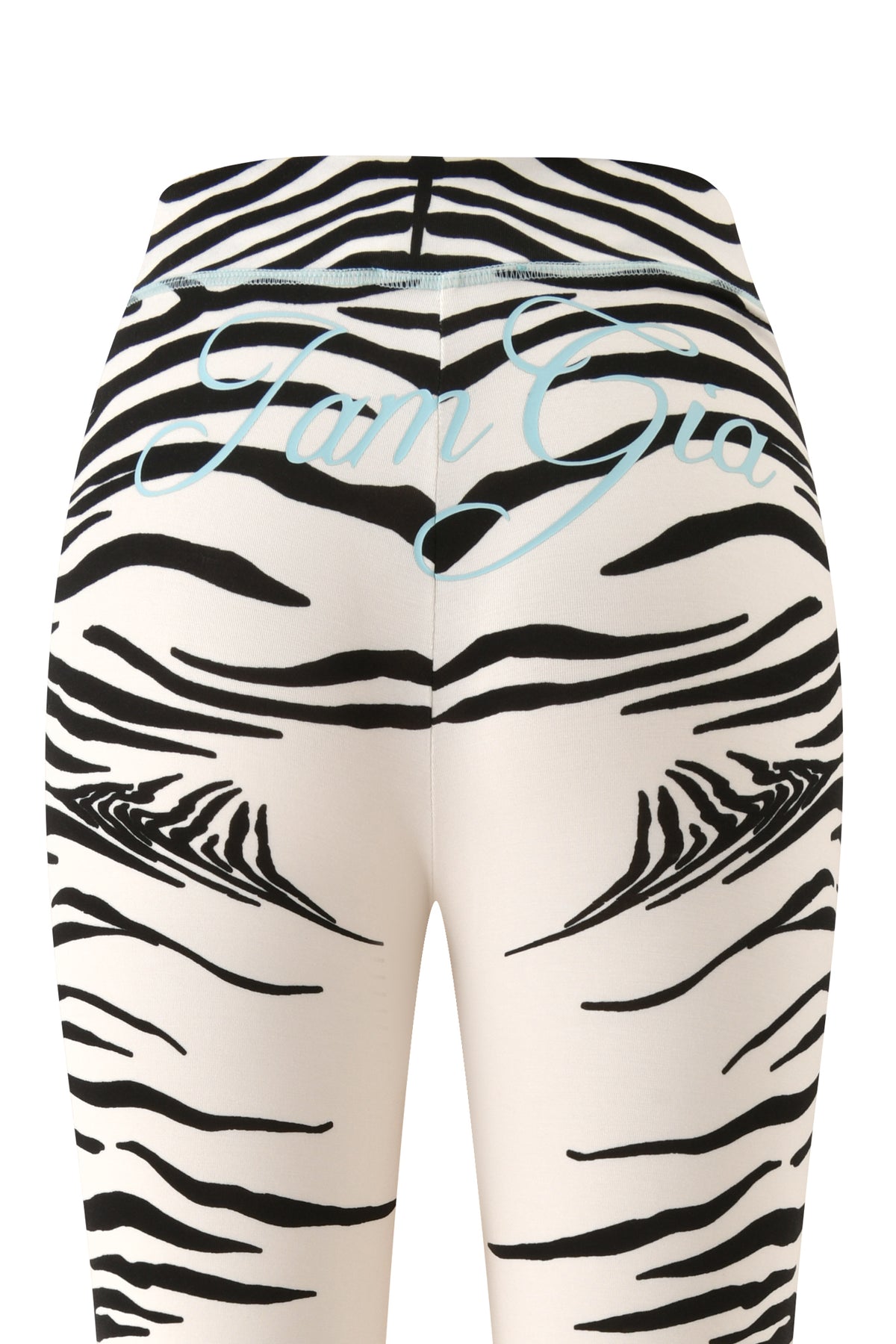 Close-up of the back of the white BLARE TRACKPANT - FINE LINE ZEBRA by I.AM.GIA, showcasing bold black zebra stripes and light blue cursive “I.AM.GIA” text across the waistband.