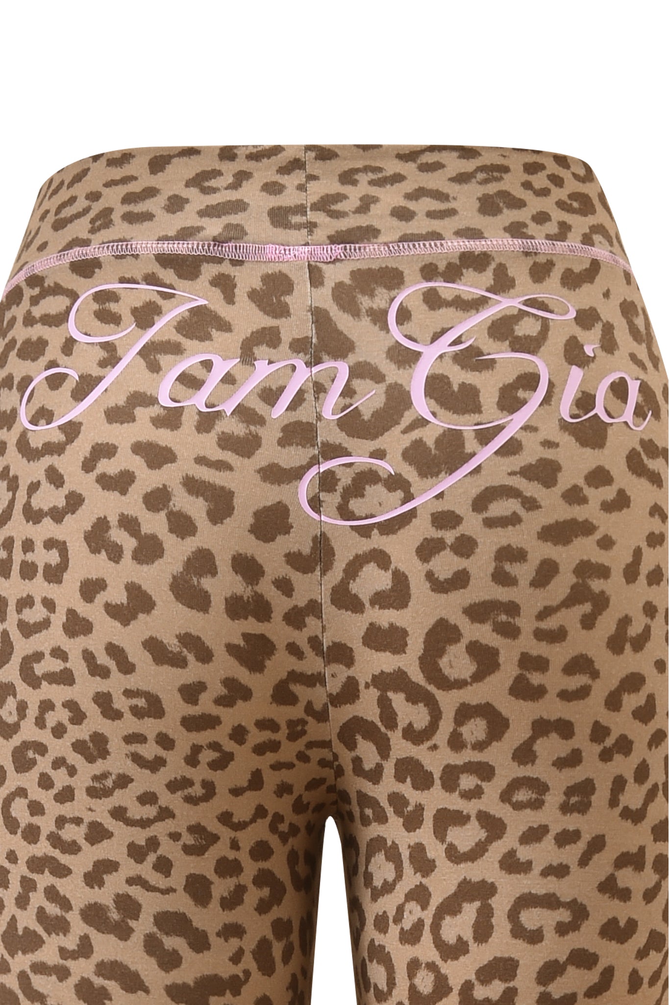 Close-up of the BLARE TRACKPANT - MOCHA LEOPARD by I.AM.GIA, showing pink cursive "I.AM.GIA" lettering across the waistband.