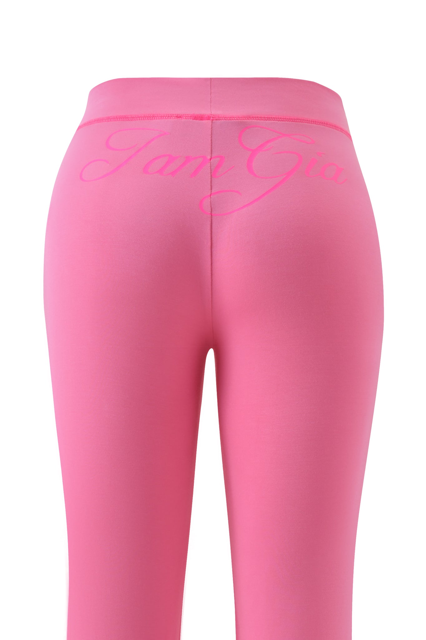 The BLARE TRACKPANT in neon pink by I.AM.GIA features a fitted, flared silhouette and showcases the bold I.AM.GIA logo in large cursive across the back waistband.