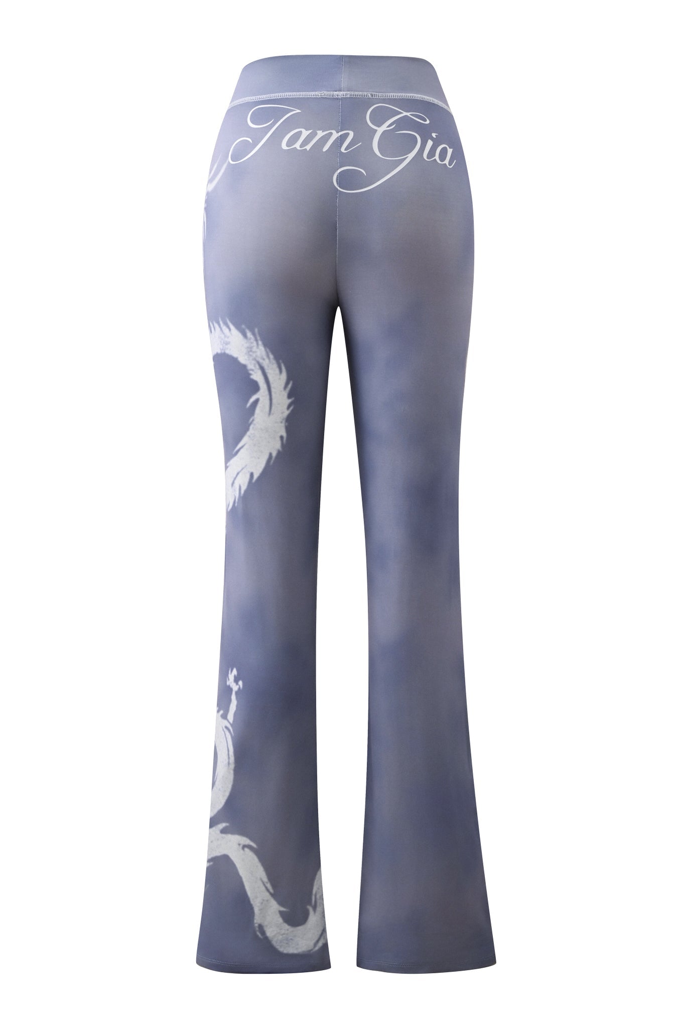 Rear view of the I.AM.GIA BLARE TRACKPANT in steel blue, showcasing a flared silhouette with a white “I am Gia” script on the waistband and a striking white dragon graphic wrapping around one leg for a bold, eye-catching look.