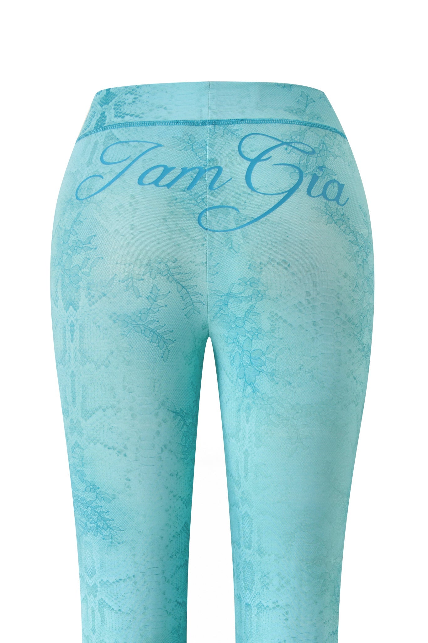 The image showcases the BLARE TRACKPANT - TEAL SERPENTINE by I.AM.GIA, featuring a teal serpentine snakeskin pattern, flared leg, and “I.AM.GIA” cursive branding on the waistband. Back view is highlighted.