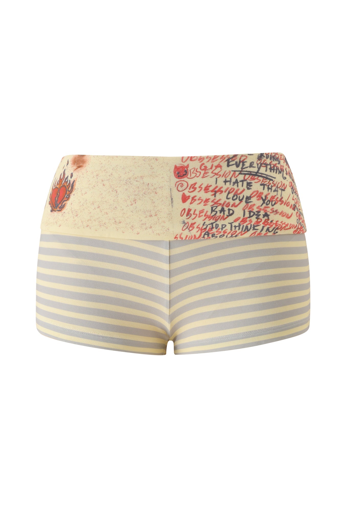 I.AM.GIA’s T-REX BLARE 2.0 SHORT - YELLOW are high-waisted mini shorts with a bodycon fit, featuring horizontal cream and gray stripes. The foldover waistband is beige with bold red graffiti-style text, a small burnt mark, and a standout red flame graphic on the left side.
