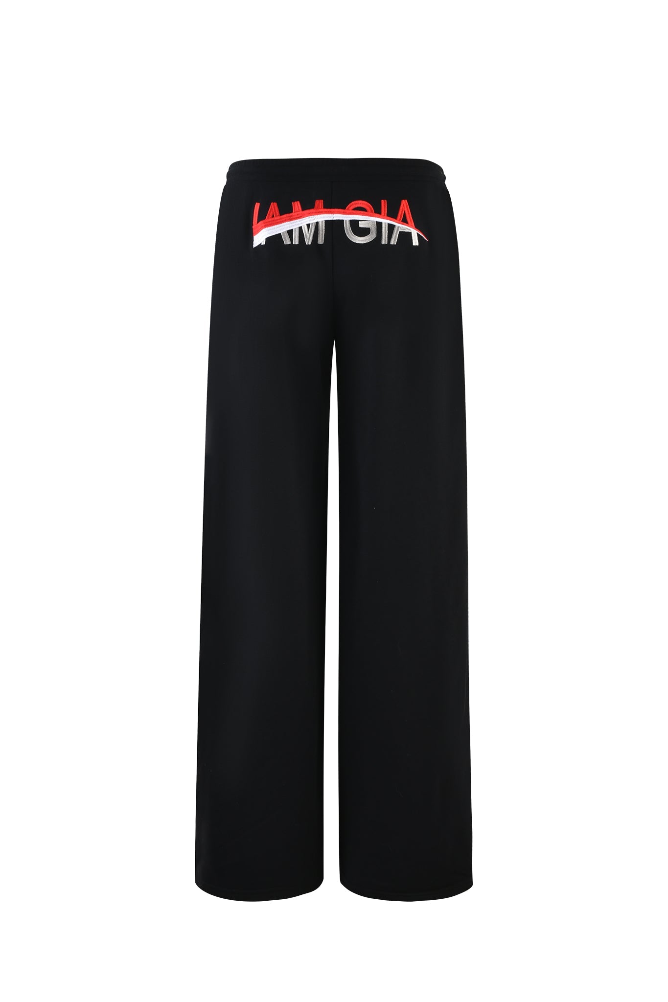 The JUSTINE PANT - BLACK by I.AM.GIA boasts a sleek and contemporary look with its wide-leg design. The back is adorned with the word "I.AM.GIA" in large, bold white letters, elegantly crossed through by a red line.