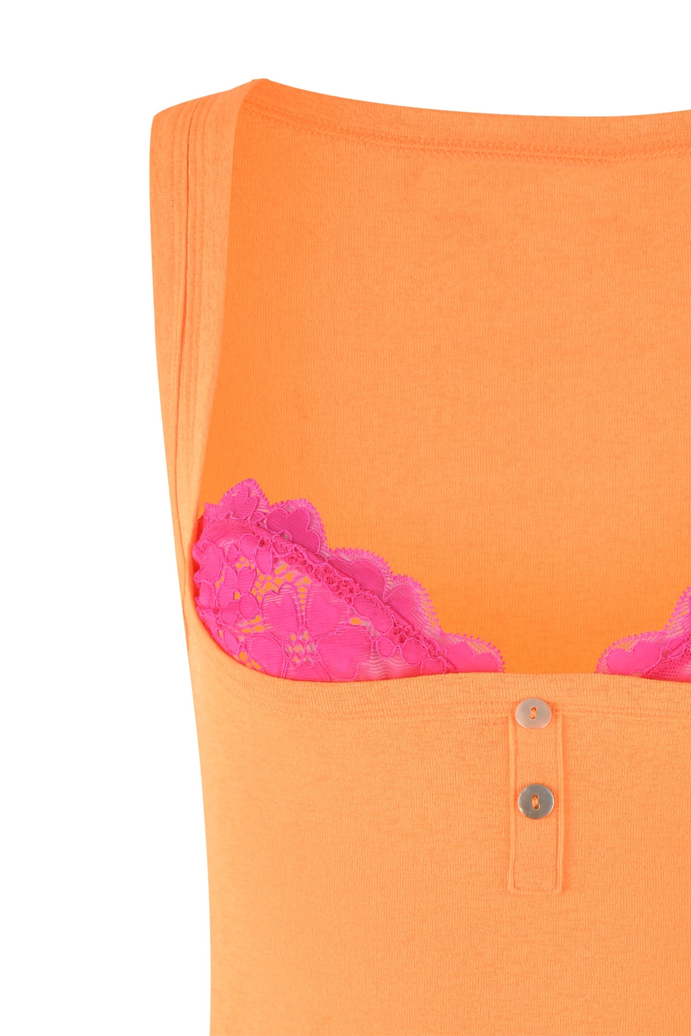 Close-up of an I.AM.GIA PIPPA MINI DRESS in Orange: Apricot, featuring a button placket at the front. Beneath the dress, a pink lace bra or bralette is partially visible. The image emphasizes the fabric textures and the contrast between the orange and pink colors, showcasing I.AM.GIA's distinctive design aesthetic.