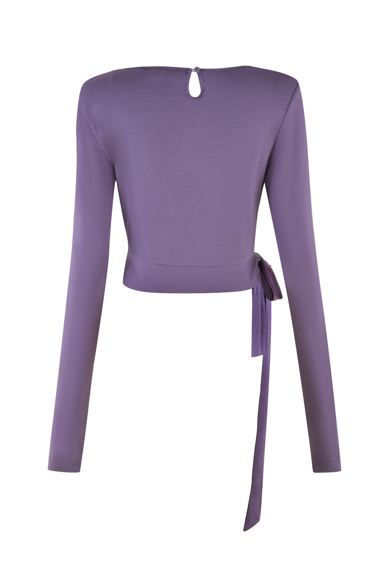 The STELLA TOP - PURPLE : DUSTY LILAC by I.AM.GIA is a bodycon wrap top with long sleeves, viewed from the back, featuring a small keyhole opening near the neck and an extended ribbon tie on the left side. Made from soft jersey fabric, this stylish and modern piece offers a chic look in its dusty lilac hue.