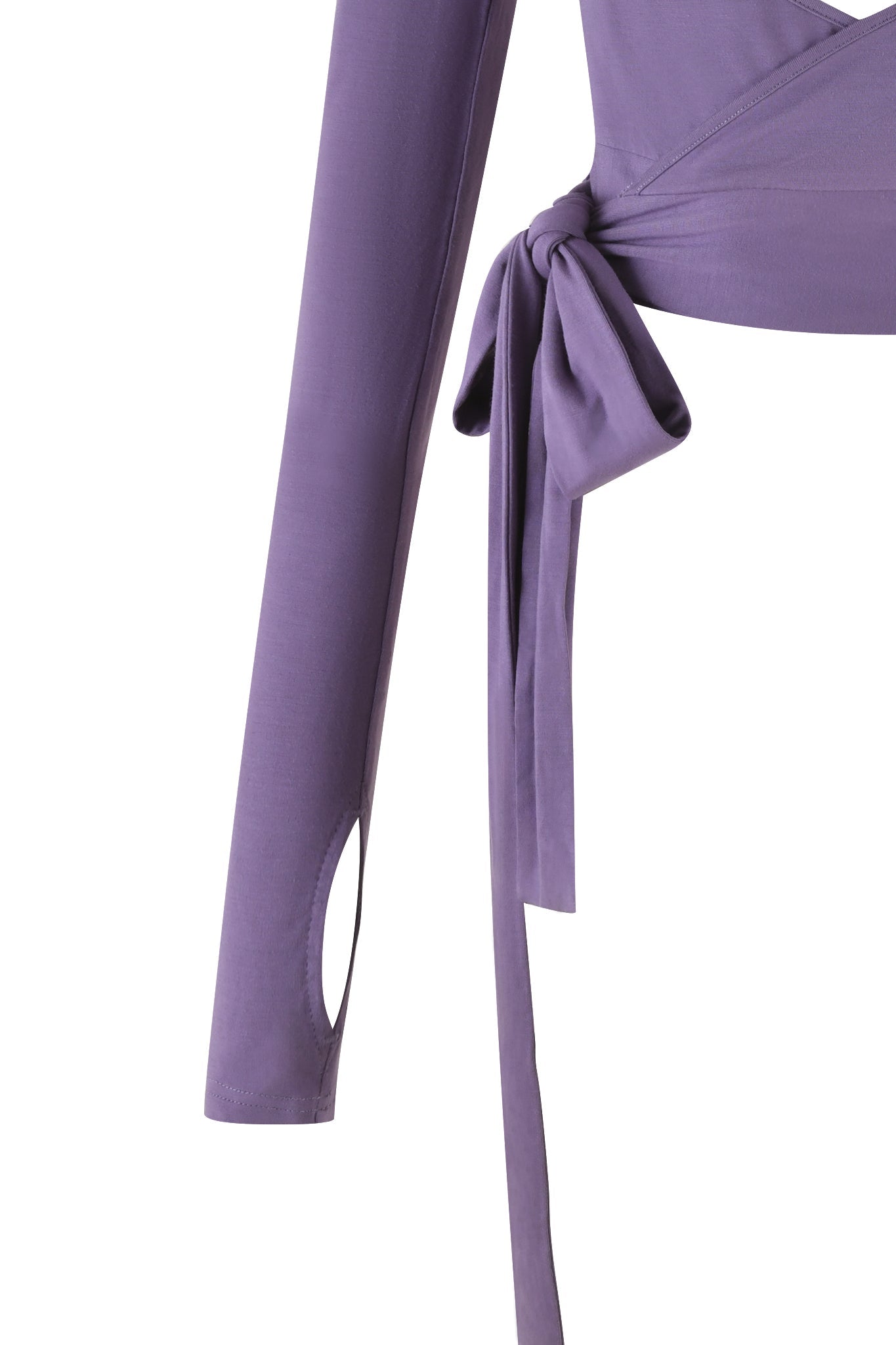 A detailed shot of the STELLA TOP - PURPLE : DUSTY LILAC by I.AM.GIA showcases its long sleeves with thumb holes near the cuffs and a wrap-around bow detail at the waist. Made from soft jersey fabric, this top ensures a comfortable and fitted bodycon silhouette.