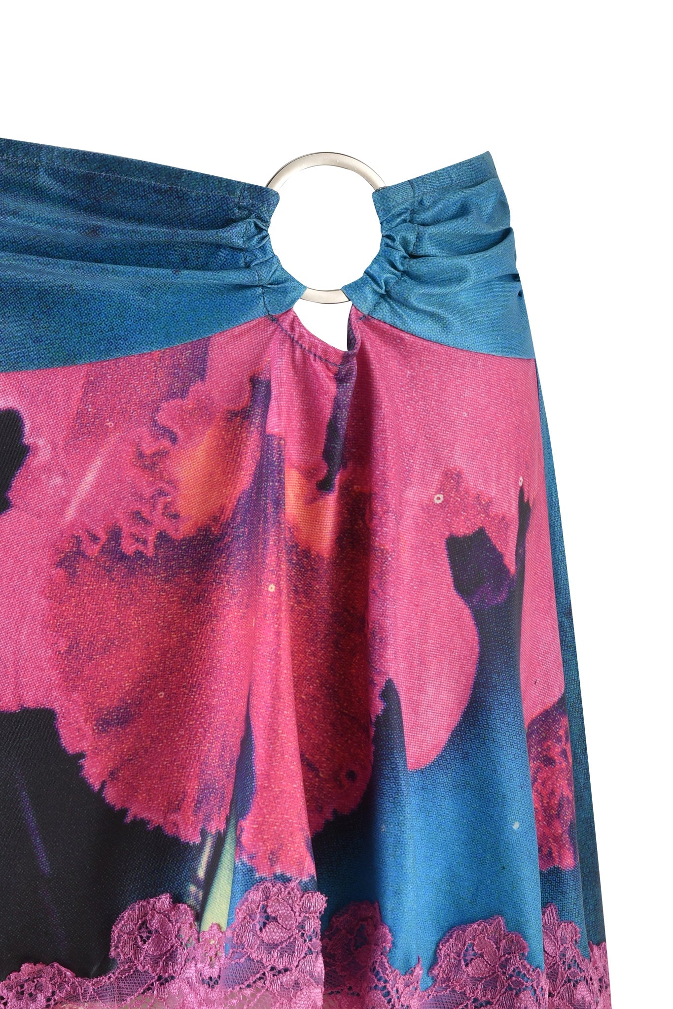 Close-up of the vibrant ODETTA SKIRT - MULTI by I.AM.GIA, showcasing a floral print in shades of pink, red, and blue. The gathered fabric at the top is held together with a silver ring, creating a stunning draped effect on this custom skirt.