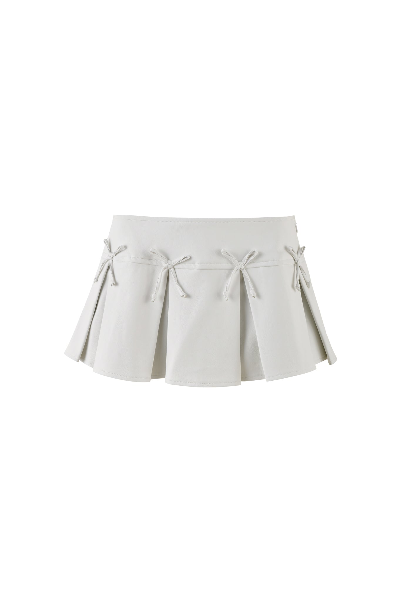 The EVERETTE SKORT - WHITE by I.AM.GIA is a chic white pleated mini skirt with a wide waistband. Each pleat is elegantly adorned with a row of small bows, creating a stylish and smooth drape against the plain white background.