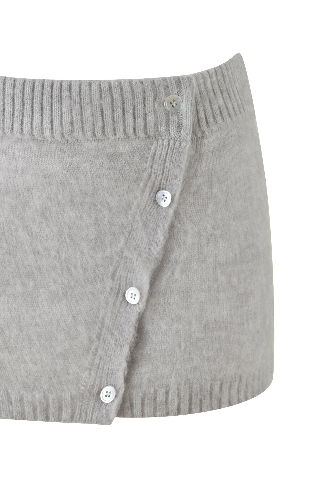 The BEATRIZ MINI SKIRT - GREY : MARLE by I.AM.GIA showcases a close-up view of its ribbed texture and knit fabric, featuring a stylish row of small white buttons arranged diagonally from the low-rise waistband, adding charm to this cozy garment.