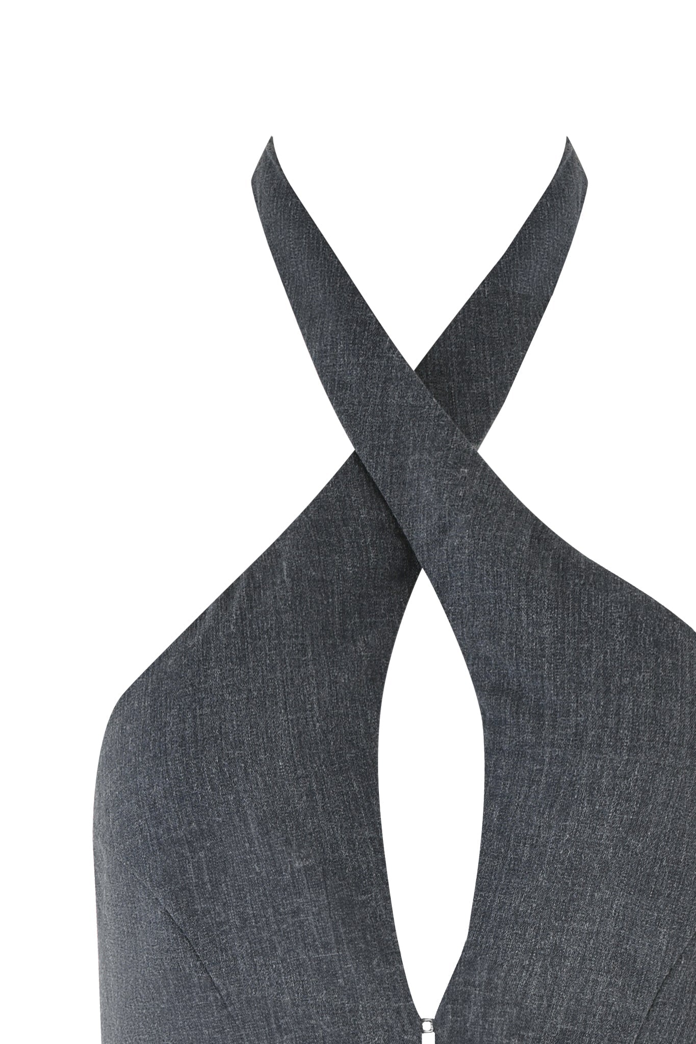 A close-up of the ADRIETTE TOP - GREY by I.AM.GIA showcases its bodycon silhouette and crisscross halter neckline. The fabric features a subtle denim or charcoal texture. At the front, the neckline crosses over, creating a small teardrop-shaped cutout that gives it an elegant tailored look.