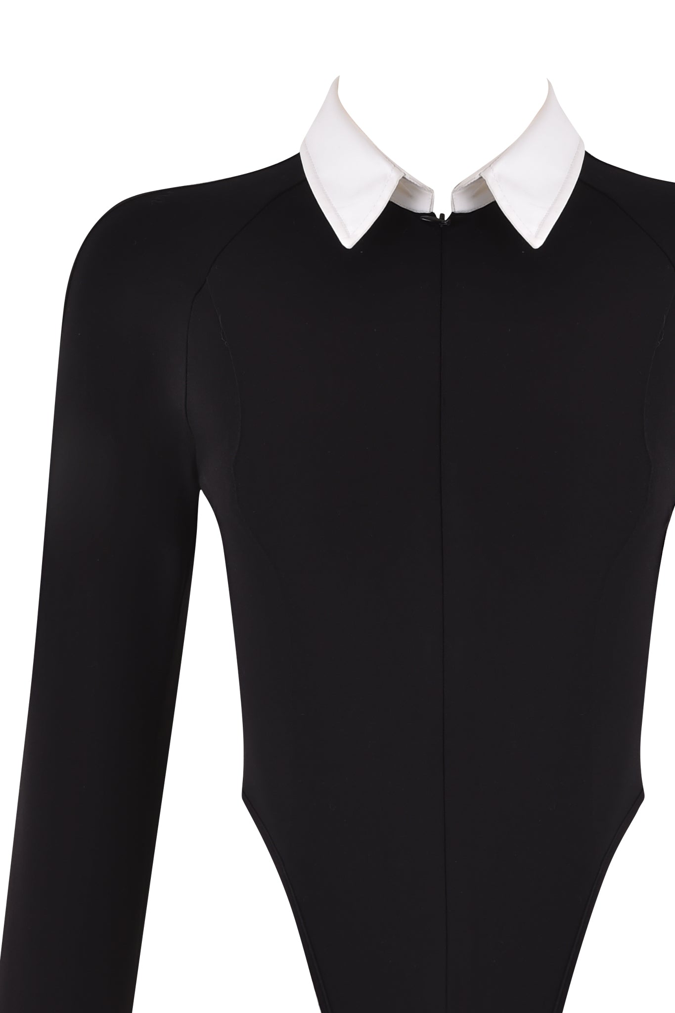 A close-up image of the TARA TUXEDO BODYSUIT - BLACK by I.AM.GIA, a black, long-sleeved bodysuit featuring a distinctive white pointed collar. The collar stands out sharply against the black fabric, creating a striking contrast. The garment is designed with a central seam running from the collar down the front, emphasizing its bodycon silhouette.