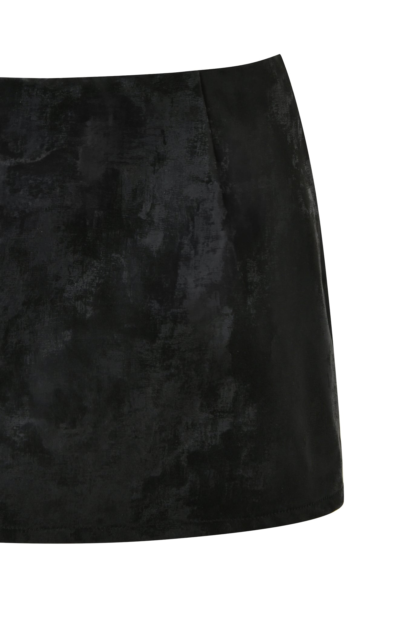 The image showcases the FRANCINE SKORT - BLACK by I.AM.GIA. This black velvet mini skort features a subtle pattern and a smooth, slightly reflective texture. The design is simple and elegant, without any visible embellishments or pockets.