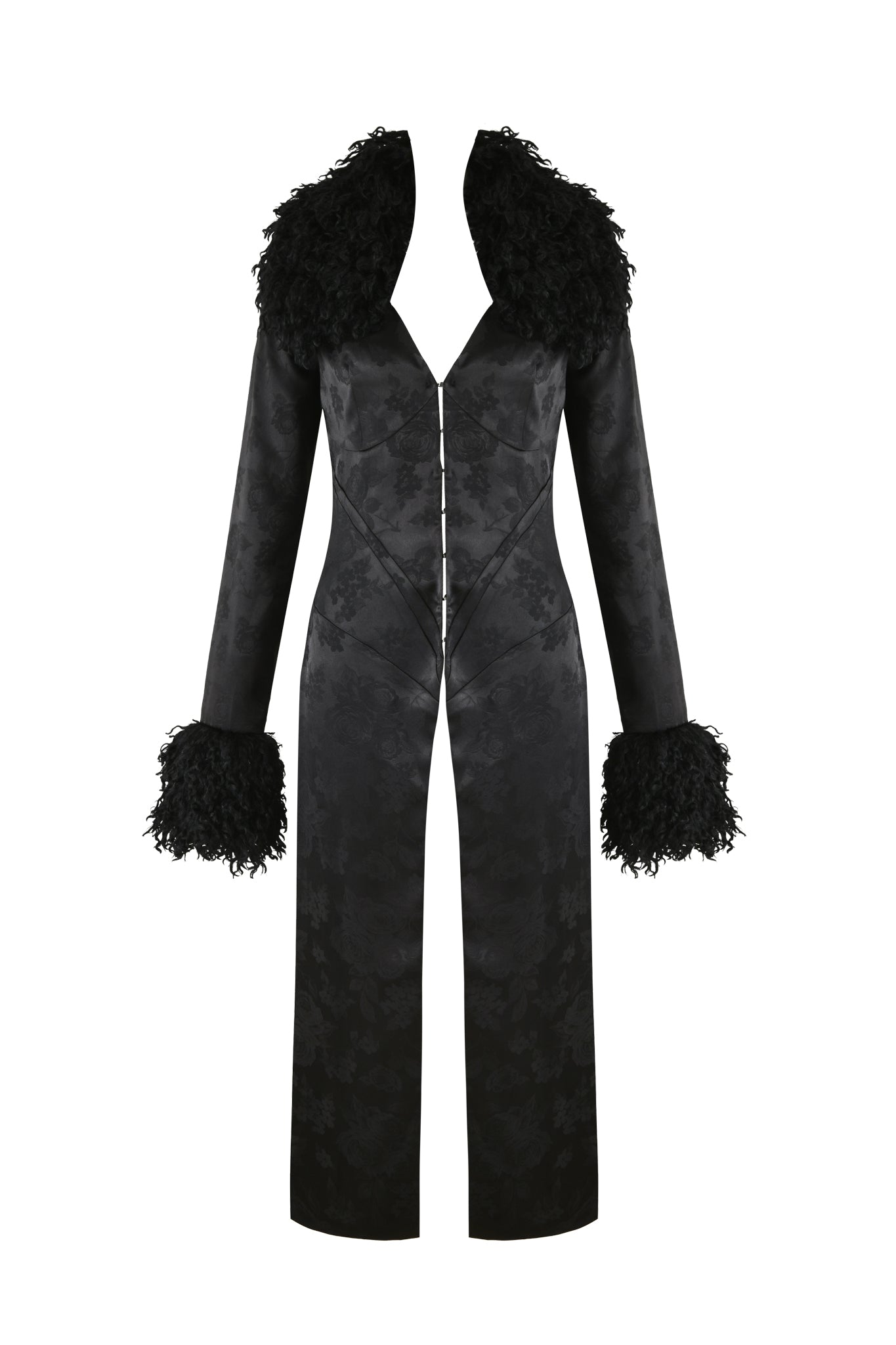 The TAMERA COAT - BLACK from I.AM.GIA is a fitted long coat featuring a deep neckline and textured faux Mongolian fur accents on the shoulders and cuffs. It has a button-up front, creating an elegant silhouette.