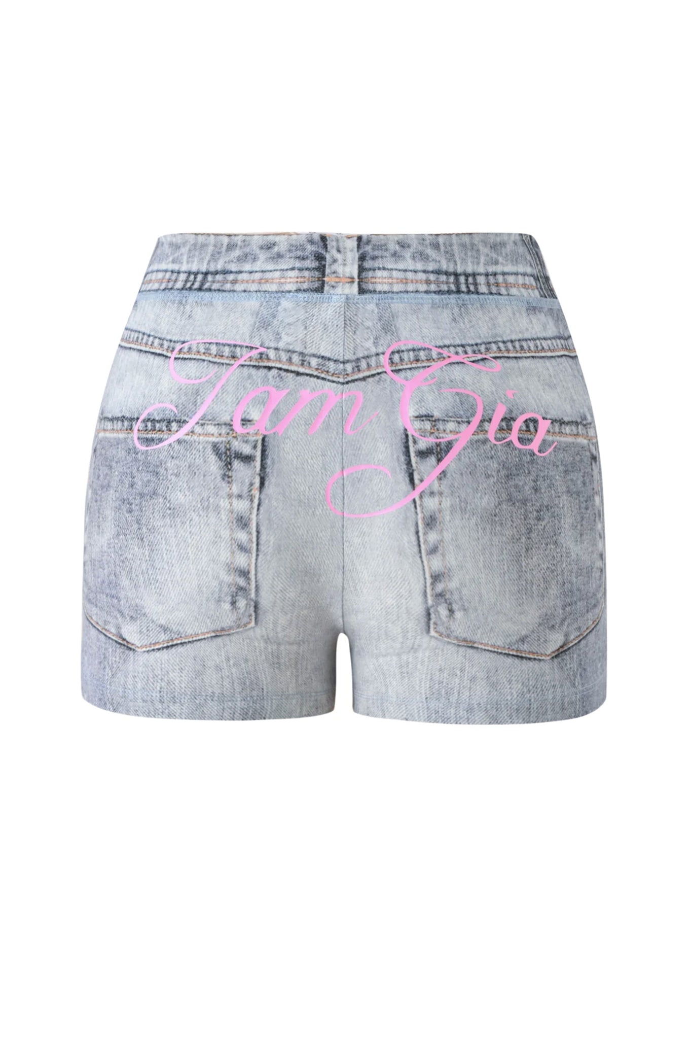 The BLARE SHORT - DENIM TROMPE L’OEIL by I.AM.GIA is shown from the back in a light blue denim wash, featuring two back pockets and “I.AM.GIA” written in pink cursive across the back.