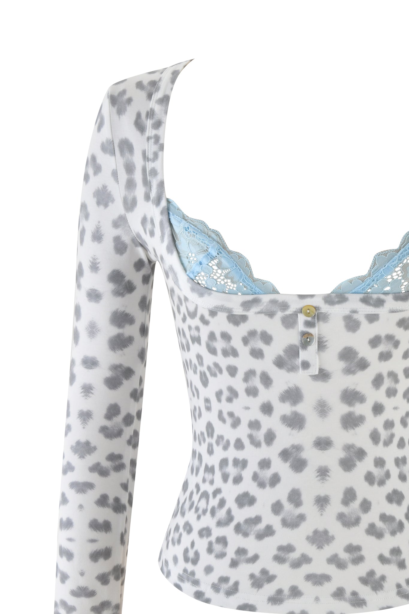 The PIPPA TOP - SNOW LEOPARD from I.AM.GIA's WINTER WILD CARD collection is shown in close-up, highlighting its gray leopard print pattern. The top resembles a bodycon fit and is adorned with a light blue lace trim around the neckline, along with a small decorative button at the center, all against a plain white background.