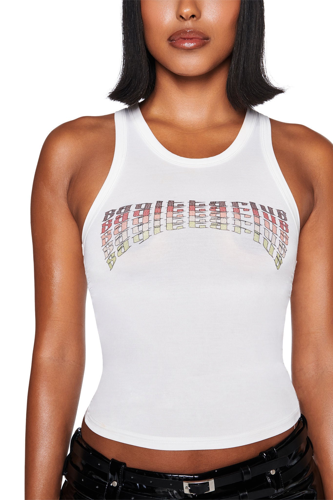 A person wearing the SAGITTARIUS ZODIAC TANK in white from I.AM.GIA, featuring a colorful text design across the chest, paired with black shiny pants against a plain background.