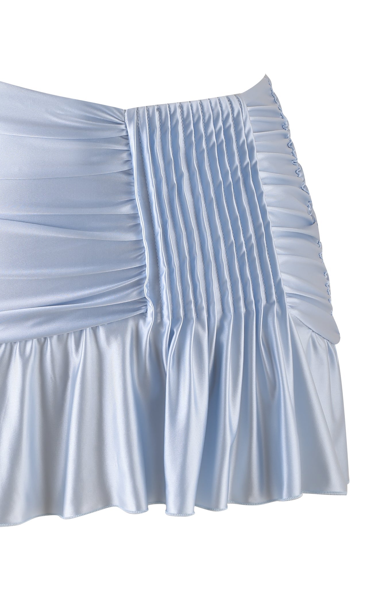 A close-up of the ELYSIA MINI SKIRT by I.AM.GIA in baby blue satin highlights micro-pleated panels and gathered fabric, with the lower part flaunting a slinky mini skirt design complete with a ruffled hem, showcasing the elegance of shiny satin knit.