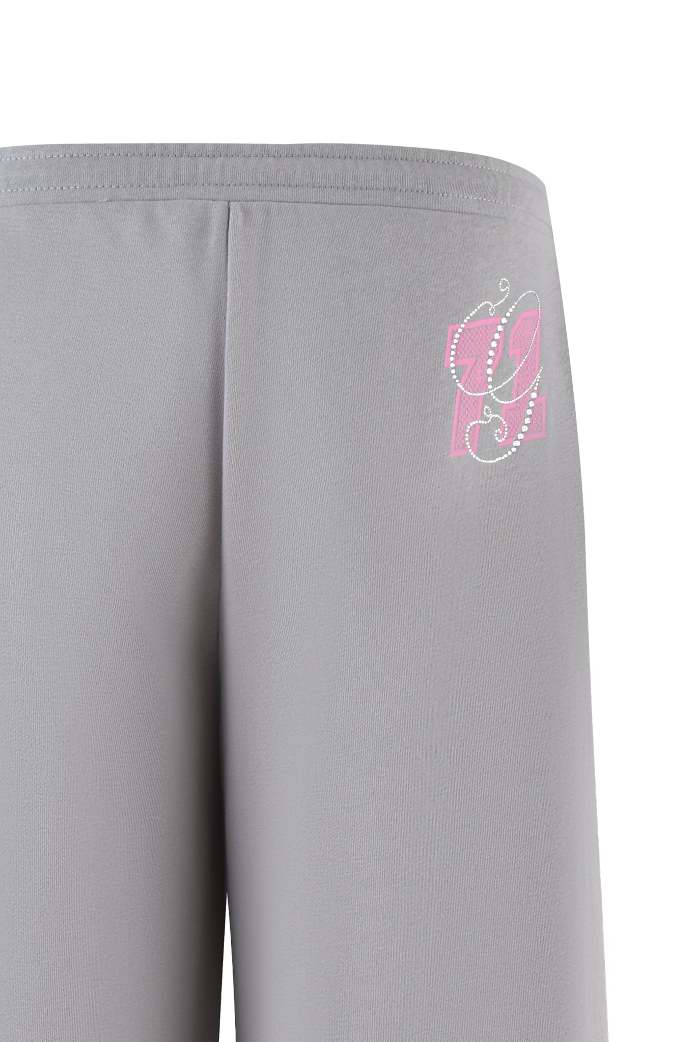 Close-up of the ARLO TRACK PANT - GREY : PINK by I.AM.GIA, showcasing a pink and white logo on the left side near the waistband. The fabric appears smooth with a slight texture, combining style and comfort.