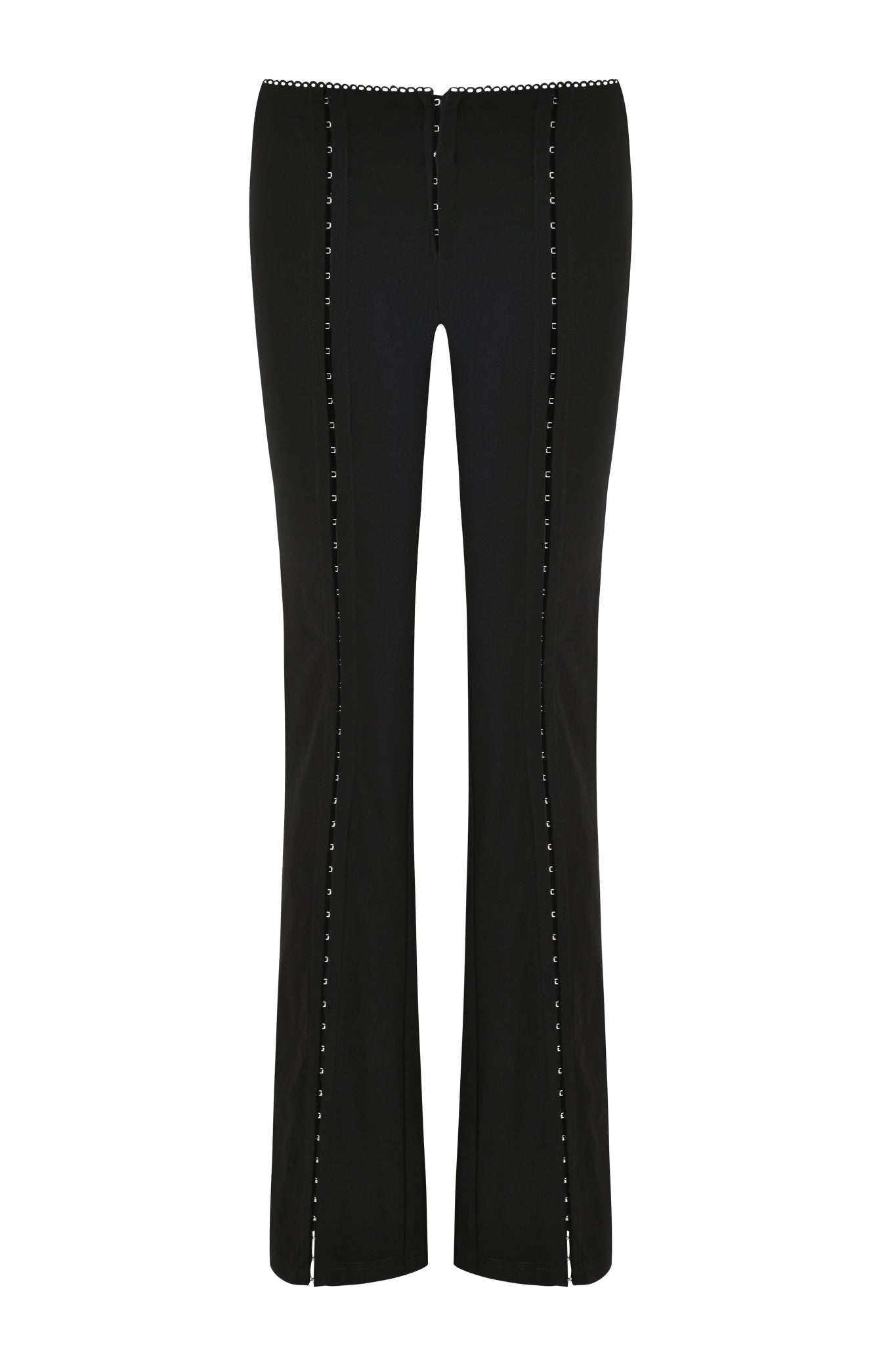 The RONAN PANT - BLACK by I.AM.GIA is made from stretch woven fabric, adorned with decorative grommet details along each leg. It features a slightly flared design with hook and eye detail, set against a plain white background.