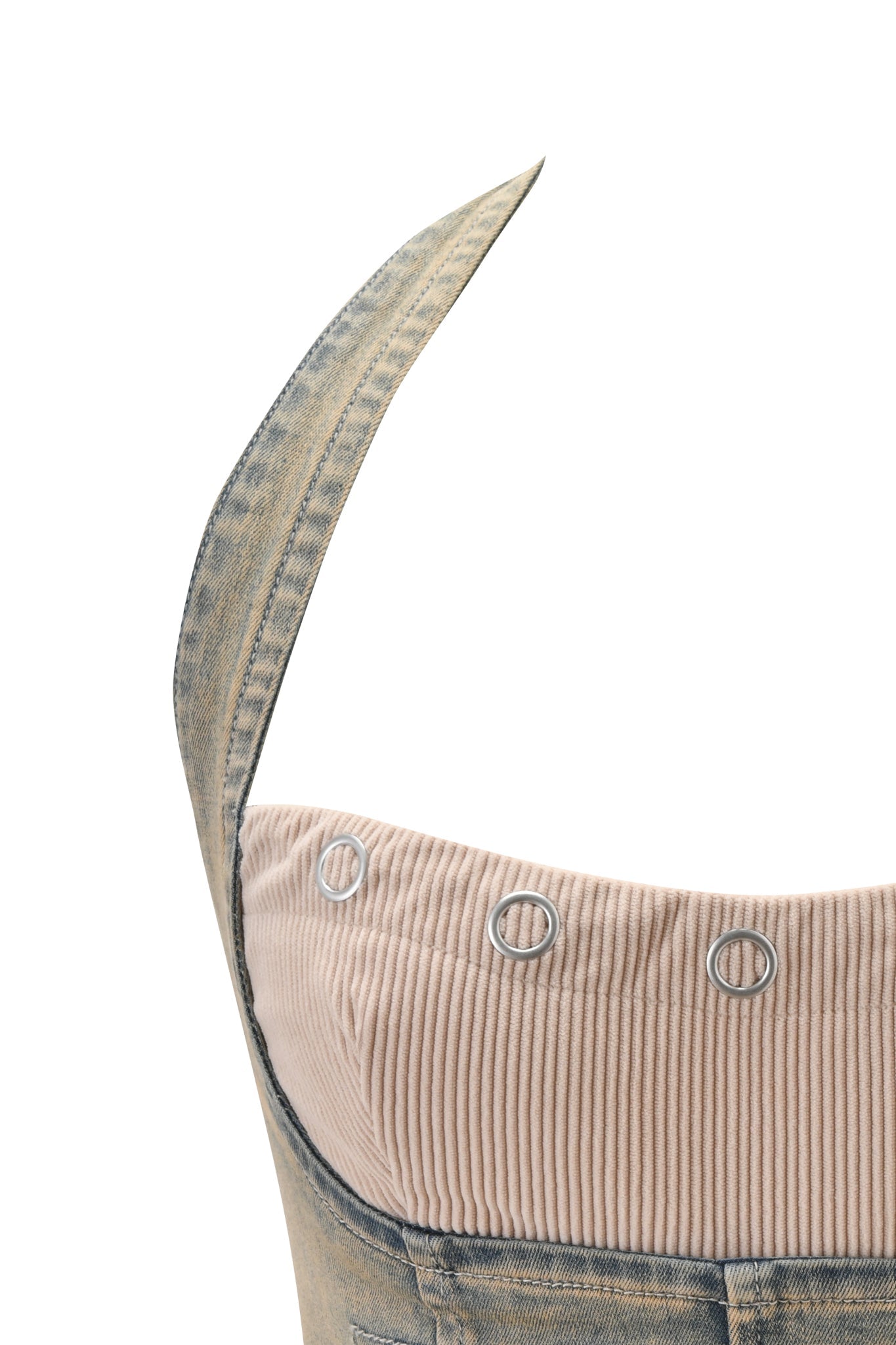Close-up of the TOMMIE CORSET - ANTIQUE DENIM by I.AM.GIA, featuring denim material, beige corduroy lining, and metal eyelets, shown against a white background.