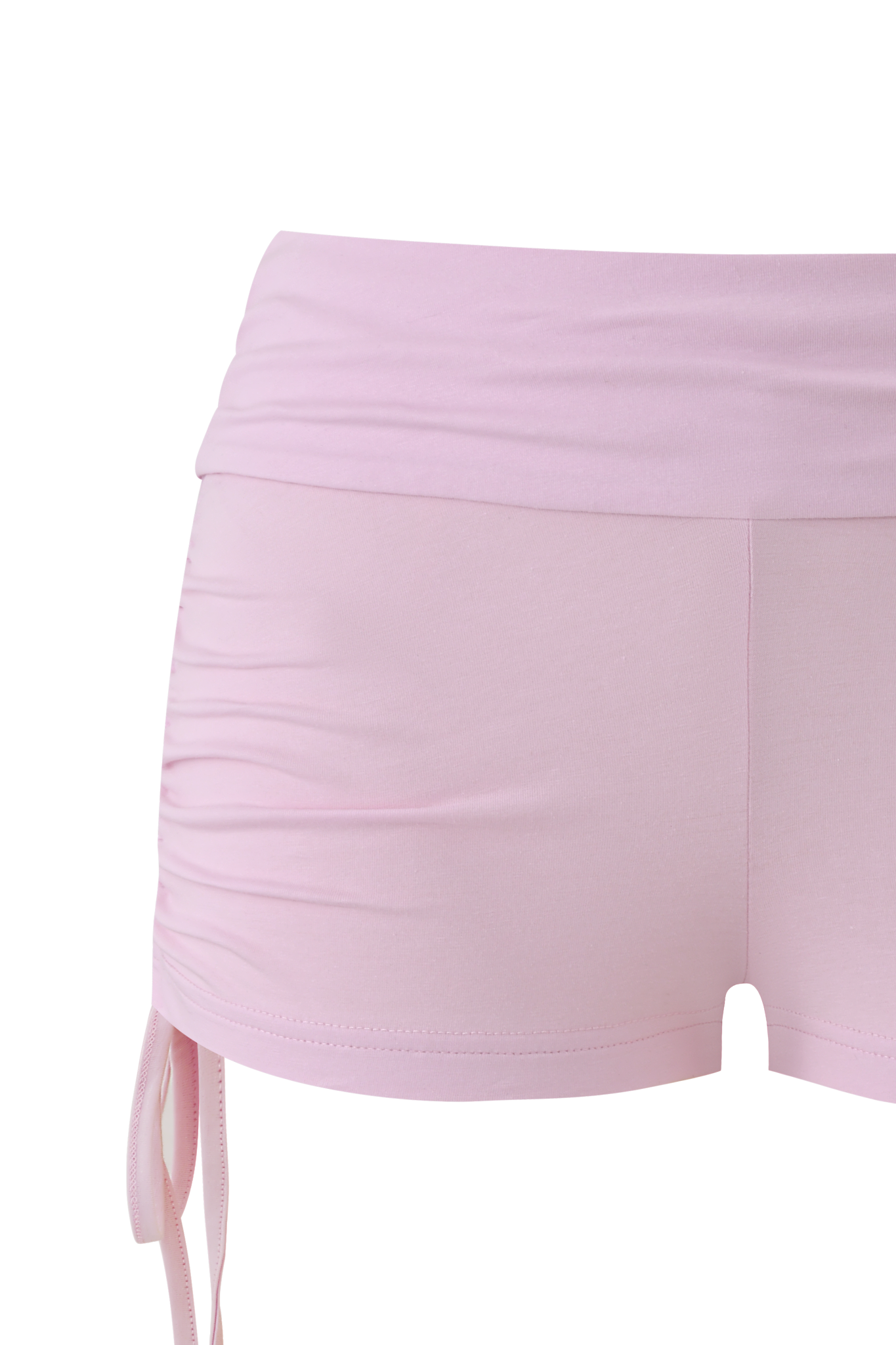 Close-up of a person wearing the I.AM.GIA MIA JERSEY SHORT in Baby Pink, featuring a high waist, ruched sides with a drawstring, crafted from soft bamboo fabric.
