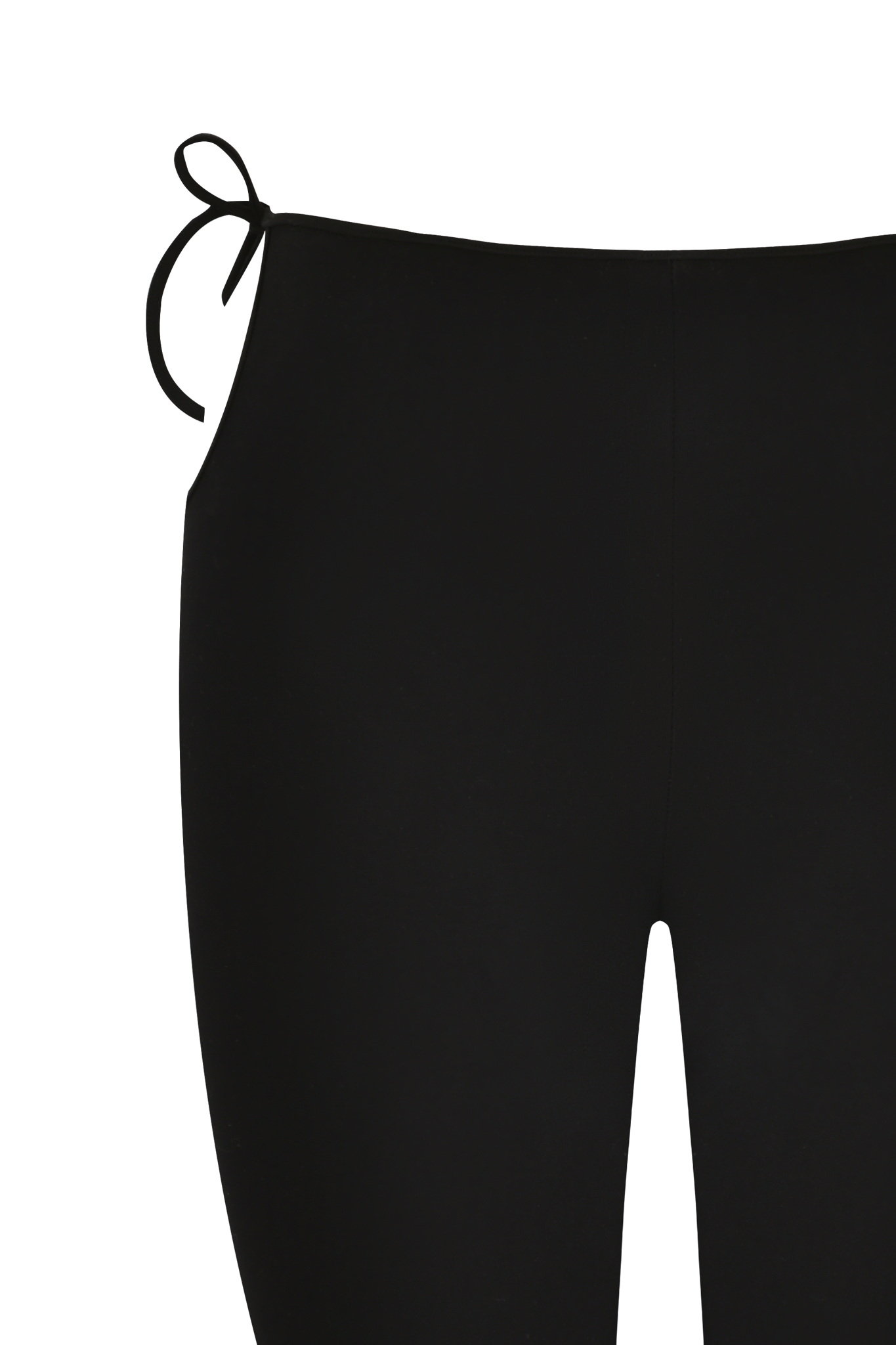 Close-up of a person wearing I.AM.GIA YUNA CAPRI - BLACK bikini bottoms with side-tie details on the left hip, featuring a flattering body-con fit against a white background.