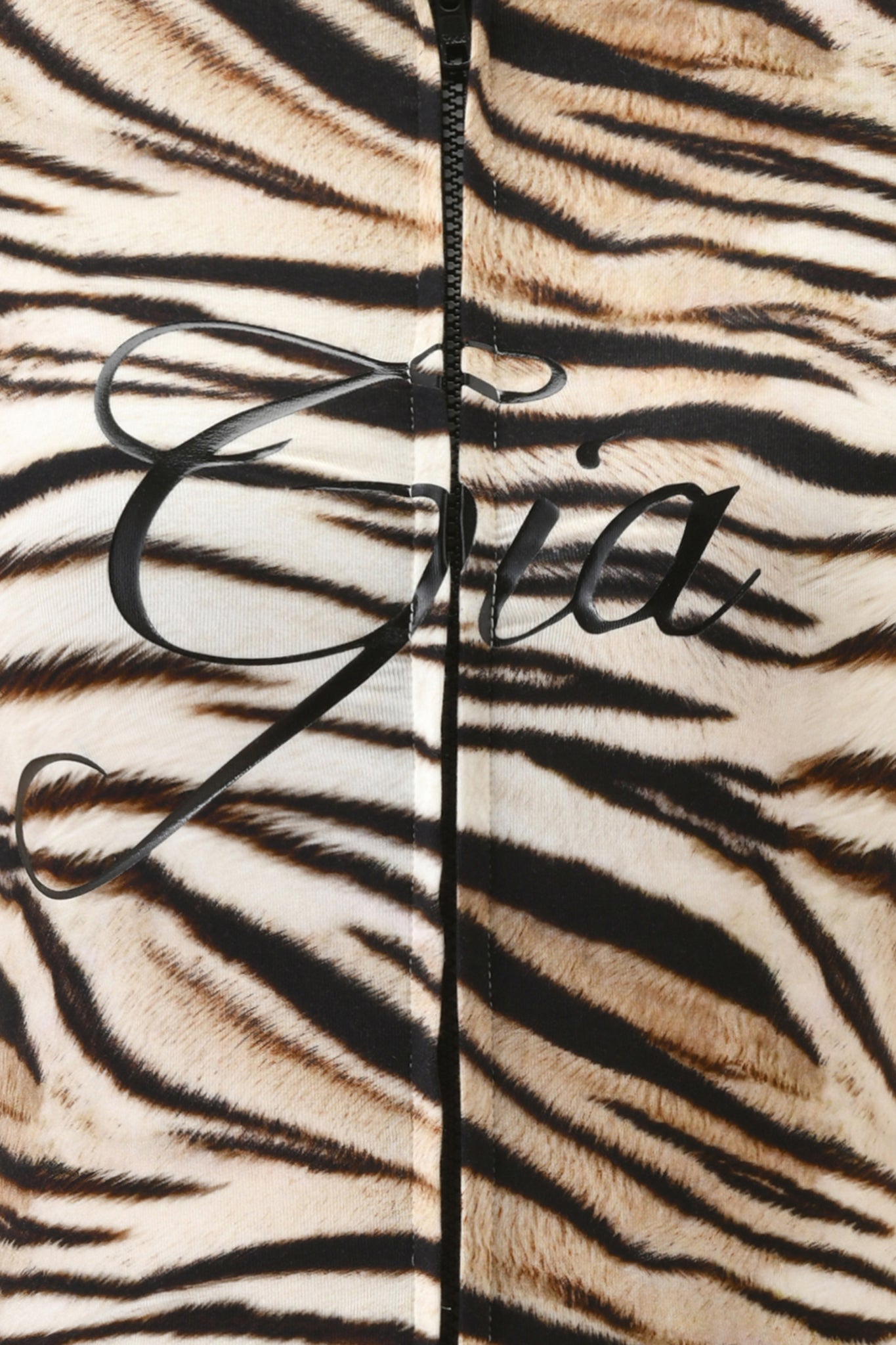 Close-up of the I.AM.GIA BLARE SHORT SLEEVE ROMPER in Light Tigress, featuring a tiger stripe print, mini short design, visible vertical zipper, and "Gia" elegantly scripted in black on the bodycon fit.
