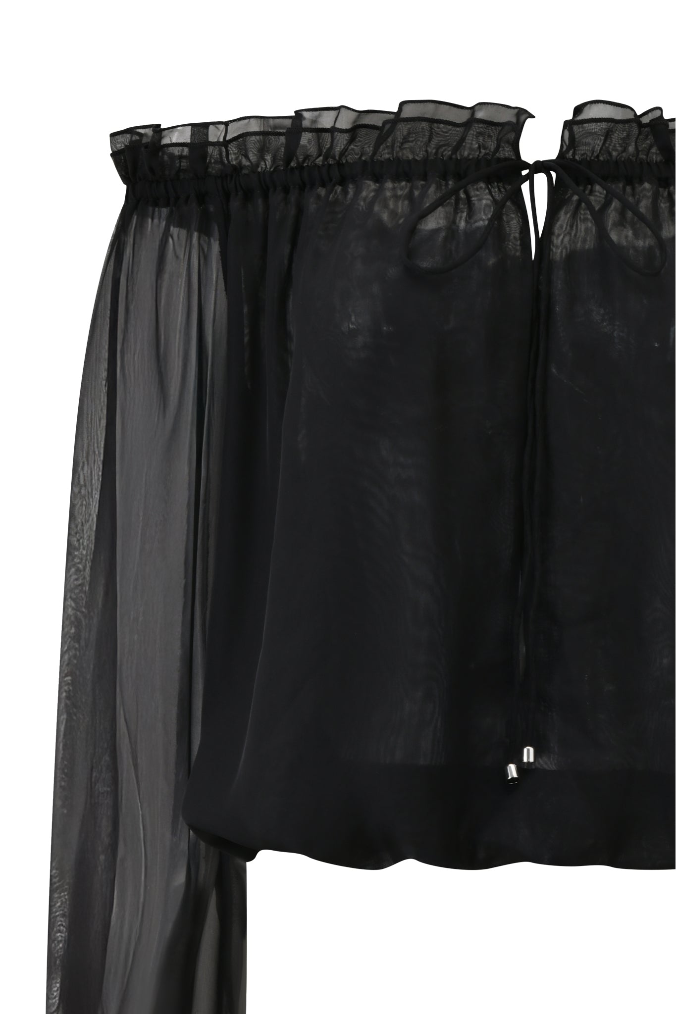 A close-up of the JAZMIN TOP - BLACK by I.AM.GIA, a sheer georgette blouse with an off-the-shoulder ruffled neckline, drawstring accents, and airy transparent fabric.