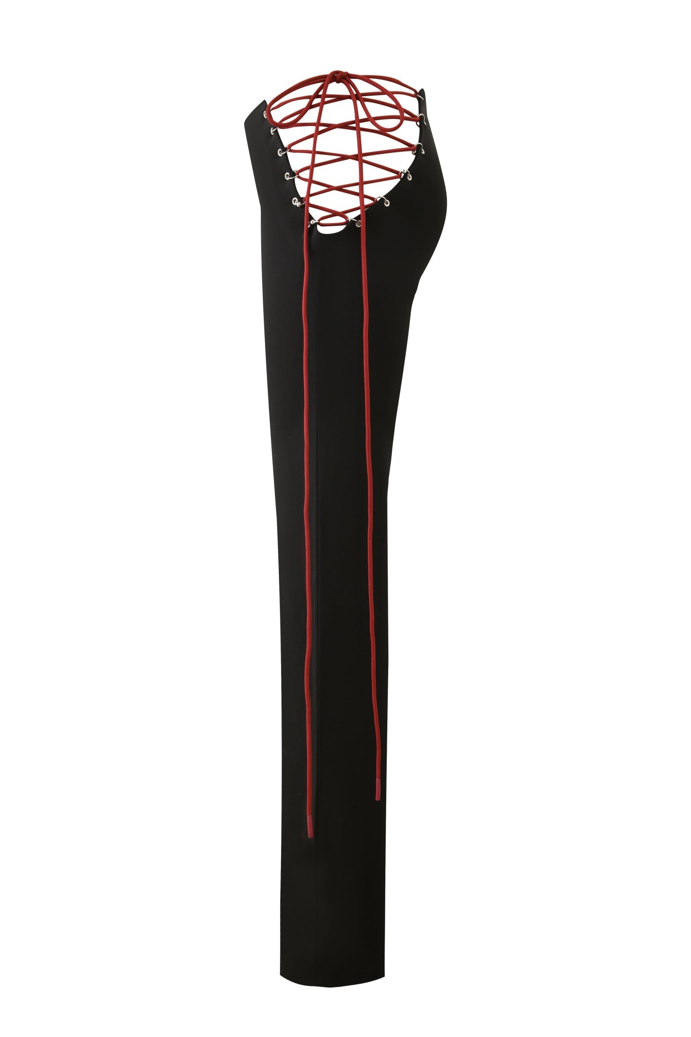 The ONYX PANT by I.AM.GIA in black, shown from the side, features an open back with red crisscross lace-up details, long dangling red laces, and a subtle cutout hip accent for a bold look.