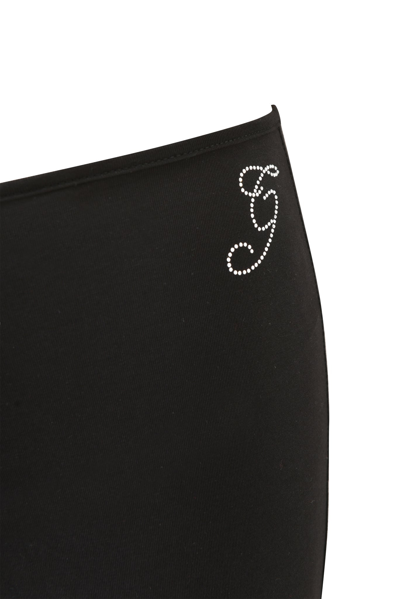 A close-up of the I.AM.GIA HALO PANT - SOLID BLACK, featuring mid-rise flared legs and a decorative rhinestone "G" near the waistband.