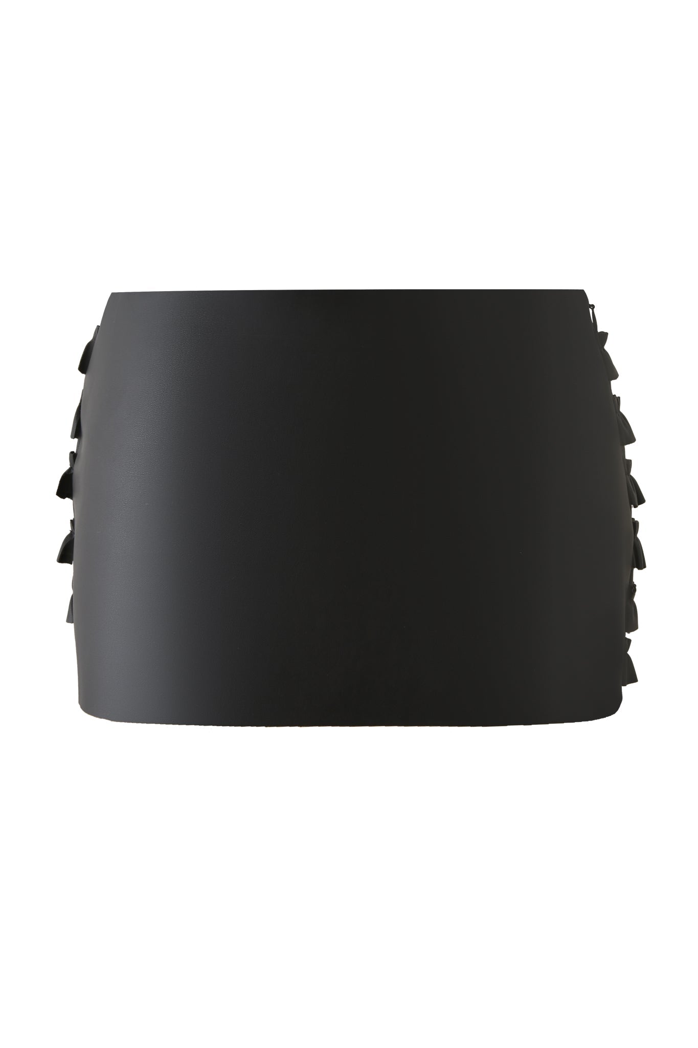 The I.AM.GIA RIVA MICRO MINI SKIRT in black features high-waisted faux leather, a smooth front, and subtle side ruffle details, shown against a white background.