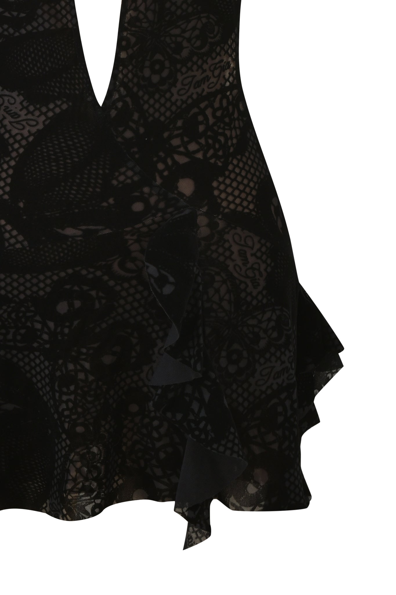 Close-up of the IRISIA MINI DRESS - BURN OUT BLACK by I.AM.GIA, a black lace mini dress with sheer fabric, deep V neckline, ruffled hem, and intricate floral pattern shown against a white background.