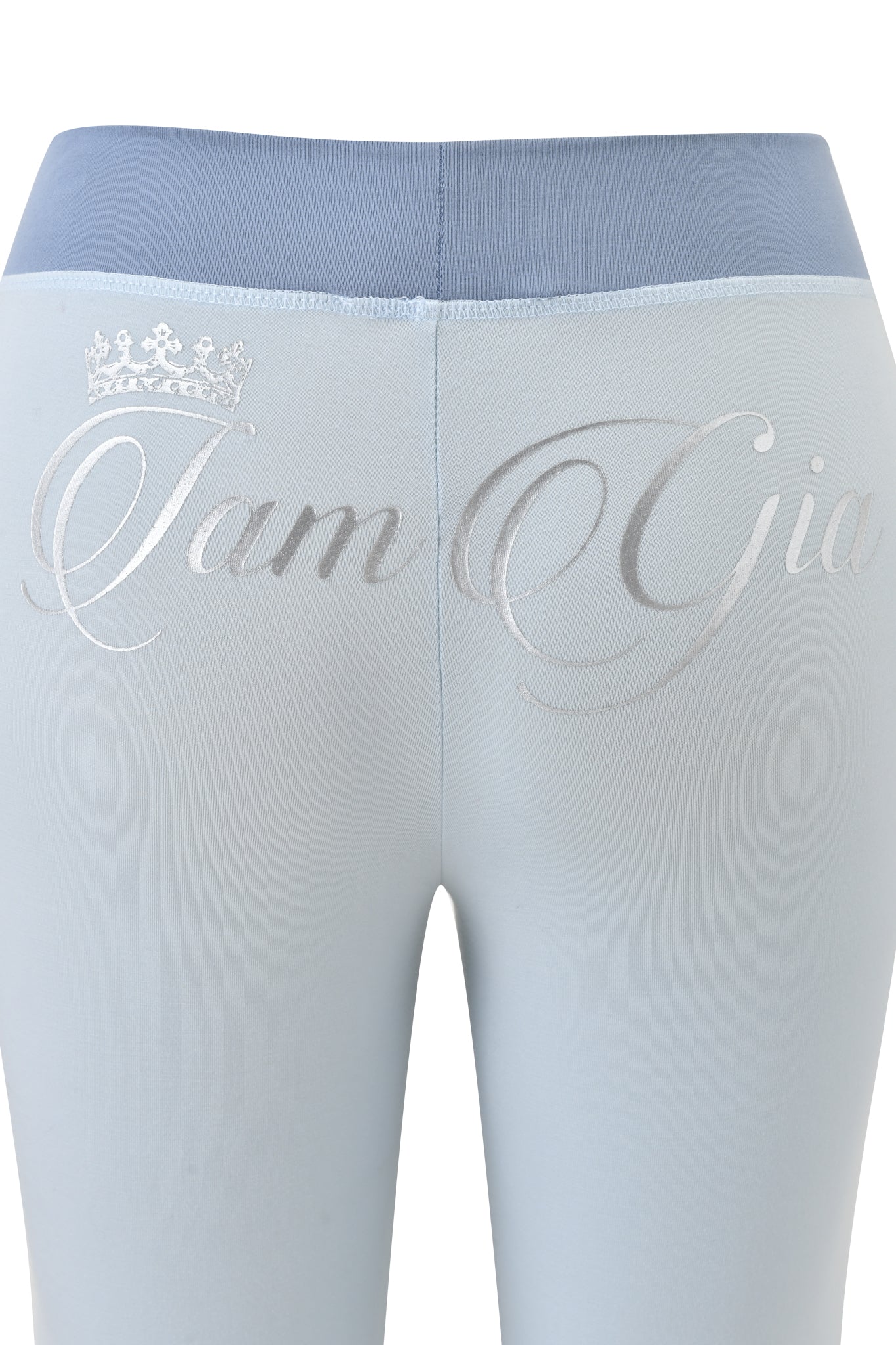 Back view of the BLARE LOWER RISE TRACKPANT - TWO TONE POWDER BLUE by I.AM.GIA, with a dark blue waistband and silver crown plus cursive "I Am Gia" on the rear—sporty pants for standout style.