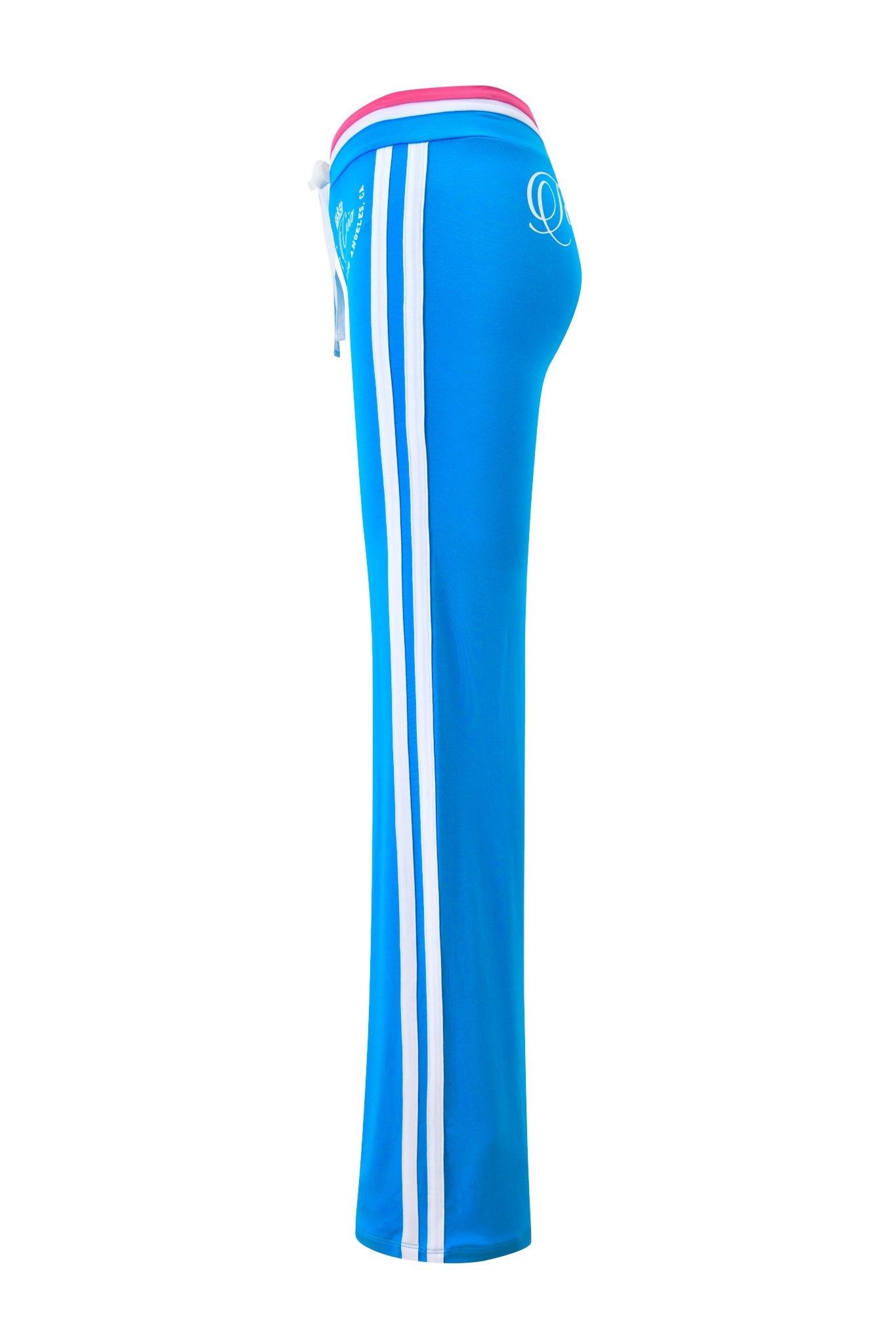 The I.AM.GIA BLARE STRIPED TRACKPANT in sky blue features straight legs, two white side stripes, a low-rise pink and white waistband with drawstring, and small white logos. Shown from the side against a white background.