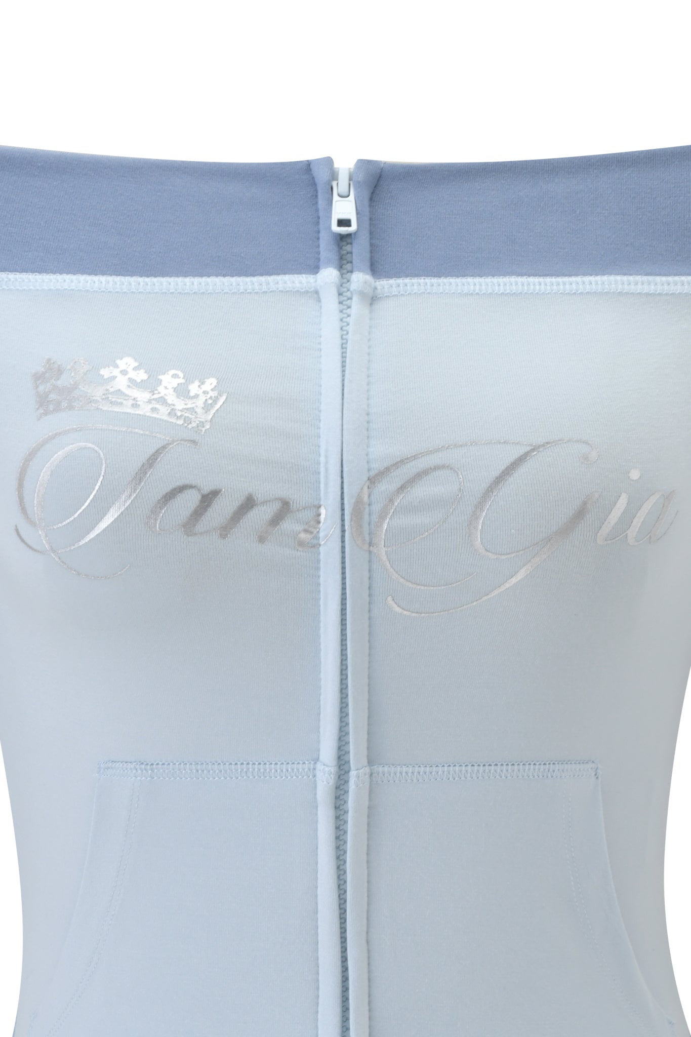 Close-up of the I.AM.GIA BLARE OFF SHOULDER TOP in two tone powder blue, featuring a center zipper, buttery-soft viscose fabric, metallic crown, and a silver foil cursive "IamGia" print across the chest. Soft and sleek feel.