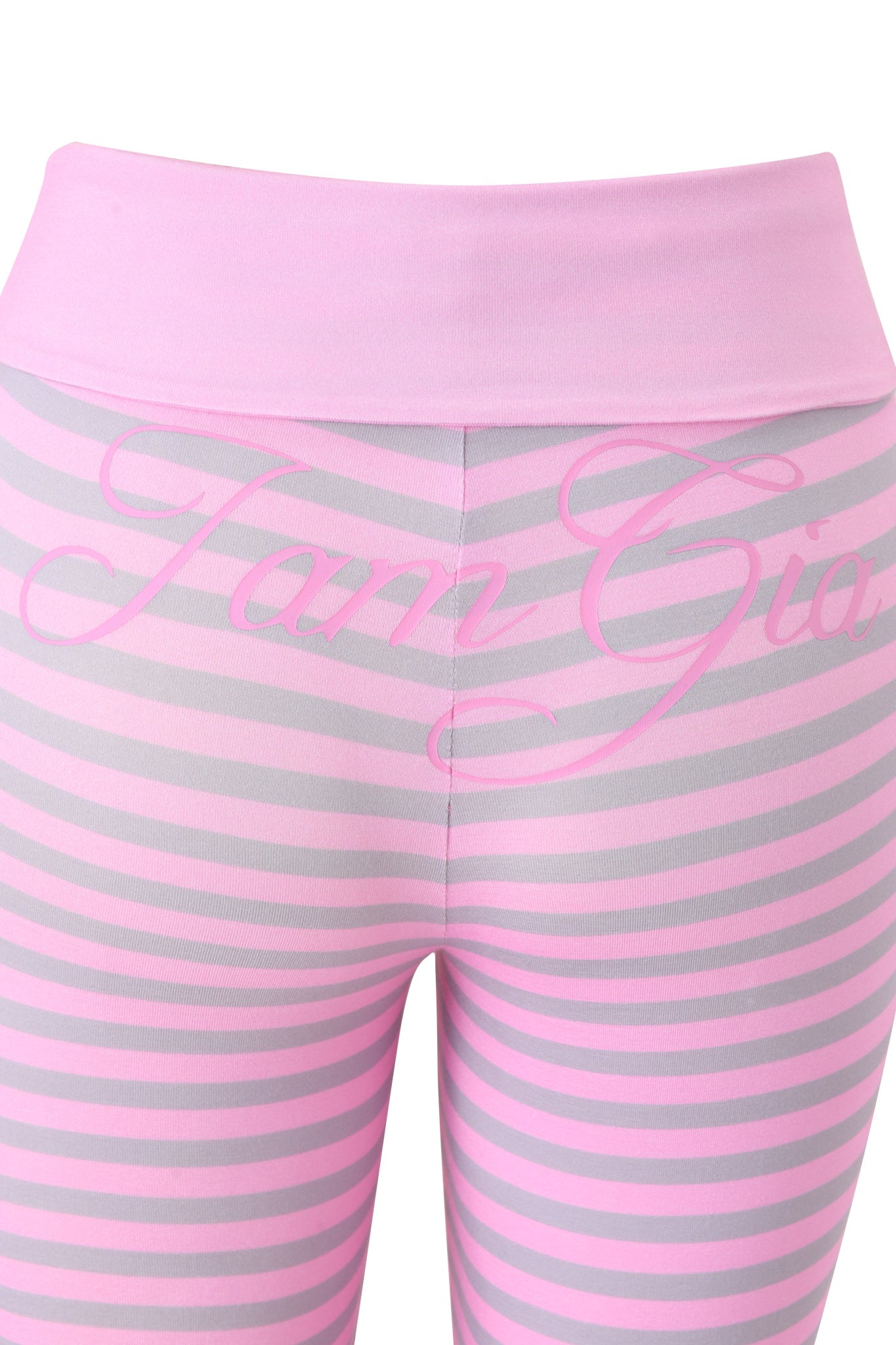 Close-up of I.AM.GIA's BLARE FOLDOVER TRACKPANT in light pink stripe, featuring a foldover waistband, flared legs, and “I.AM.GIA” in pink script across the back.