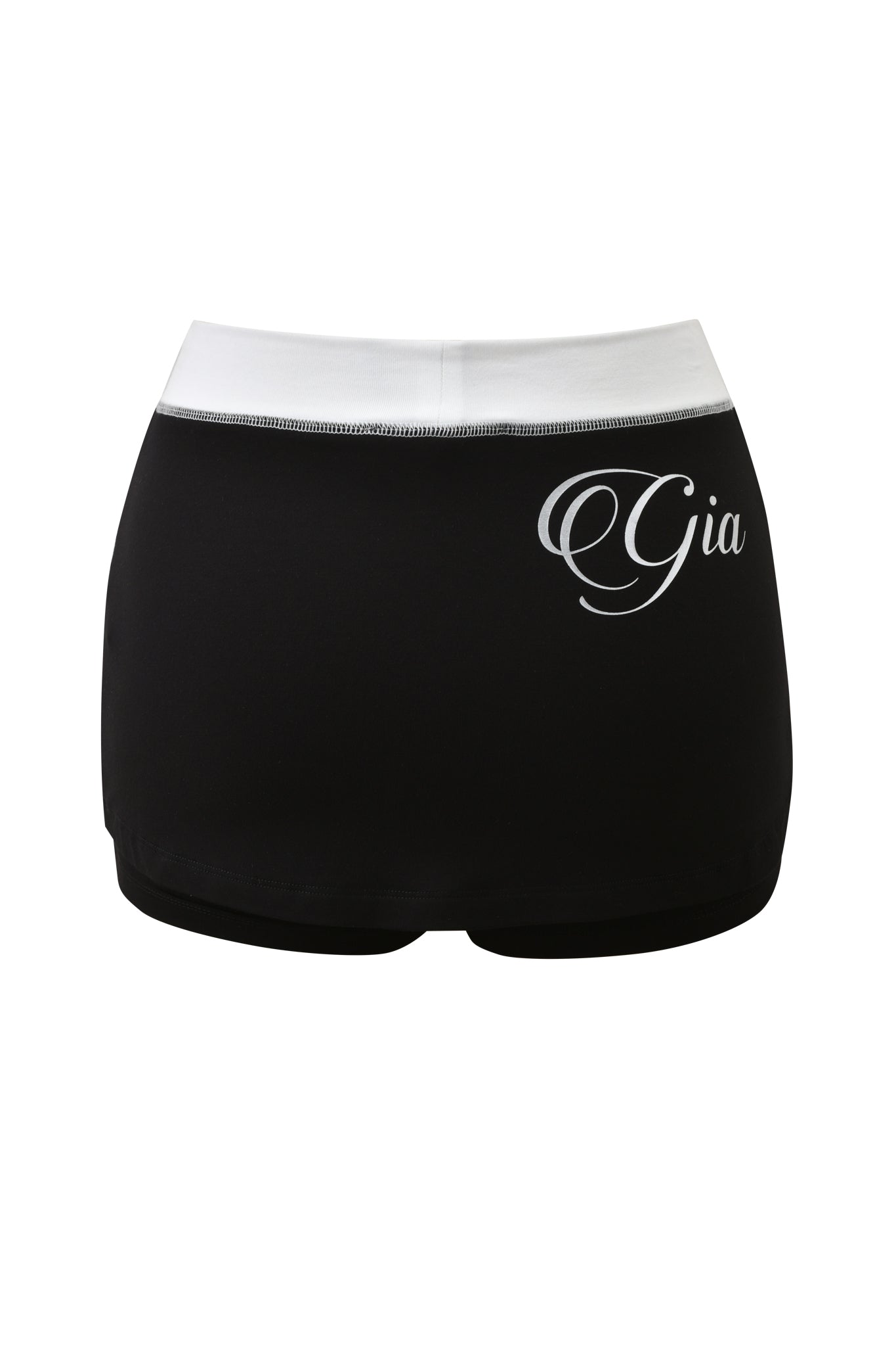 The BLARE MICRO SKORT - BLACK AND WHITE by I.AM.GIA features a mid rise waist, white waistband, and "Gia" in cursive on the left hip. Shown against a plain white background.