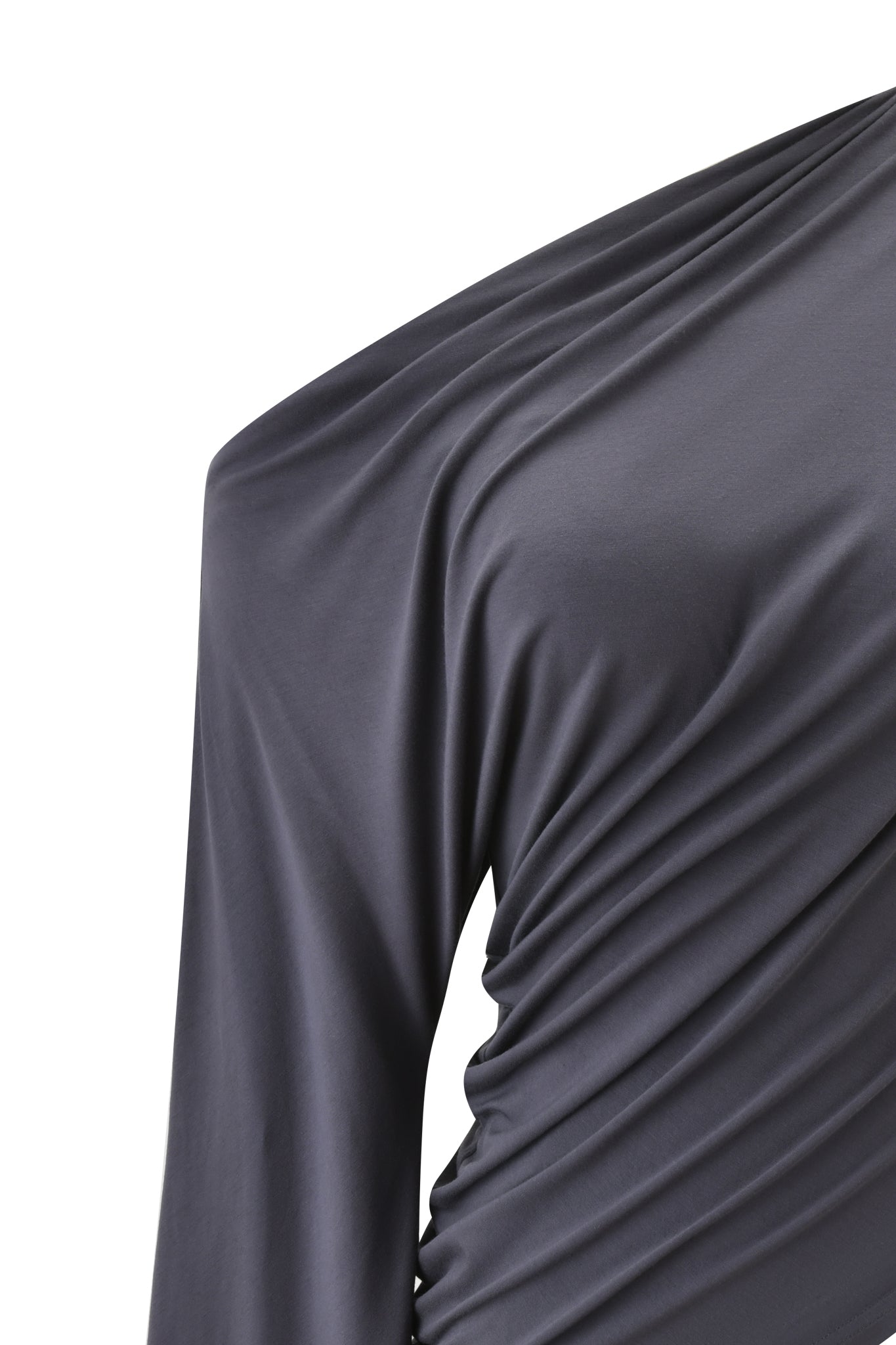 Close-up of the I.AM.GIA VIOLETTE ASYMMETRICAL TOP in grey, showcasing its off-shoulder design, asymmetrical neckline, and soft gathered fabric with draped folds from shoulder to mid-torso.