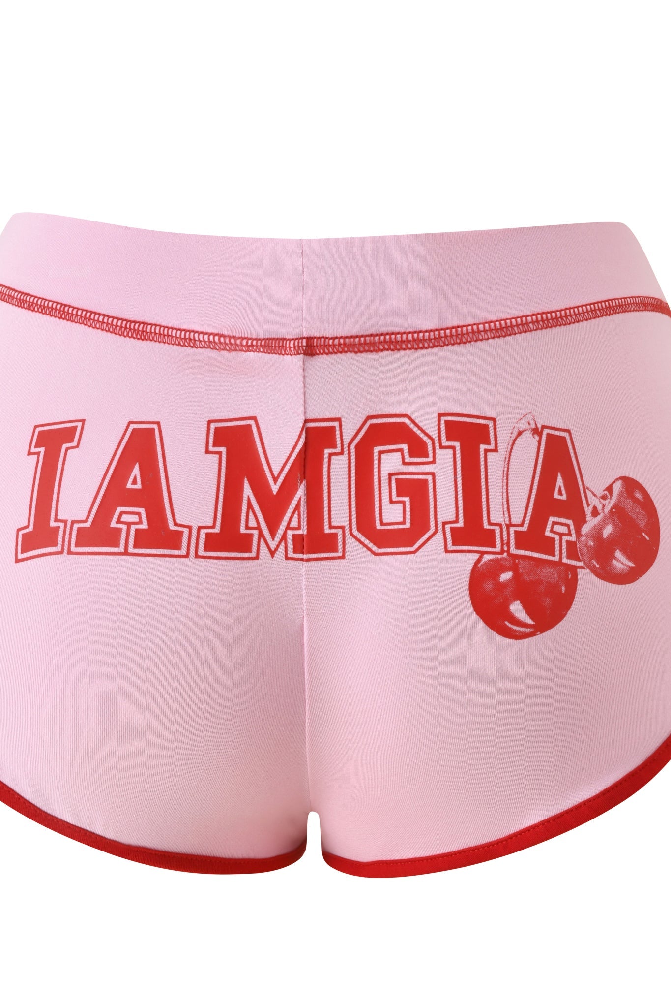 The BLARE DOLPHIN SHORT - BABY PINK by I.AM.GIA are playful mini shorts in baby pink with red trim, featuring bold red "IAMGIA" text and a cherry graphic on the back—perfect statement bamboo dolphin shorts for summer beachwear.