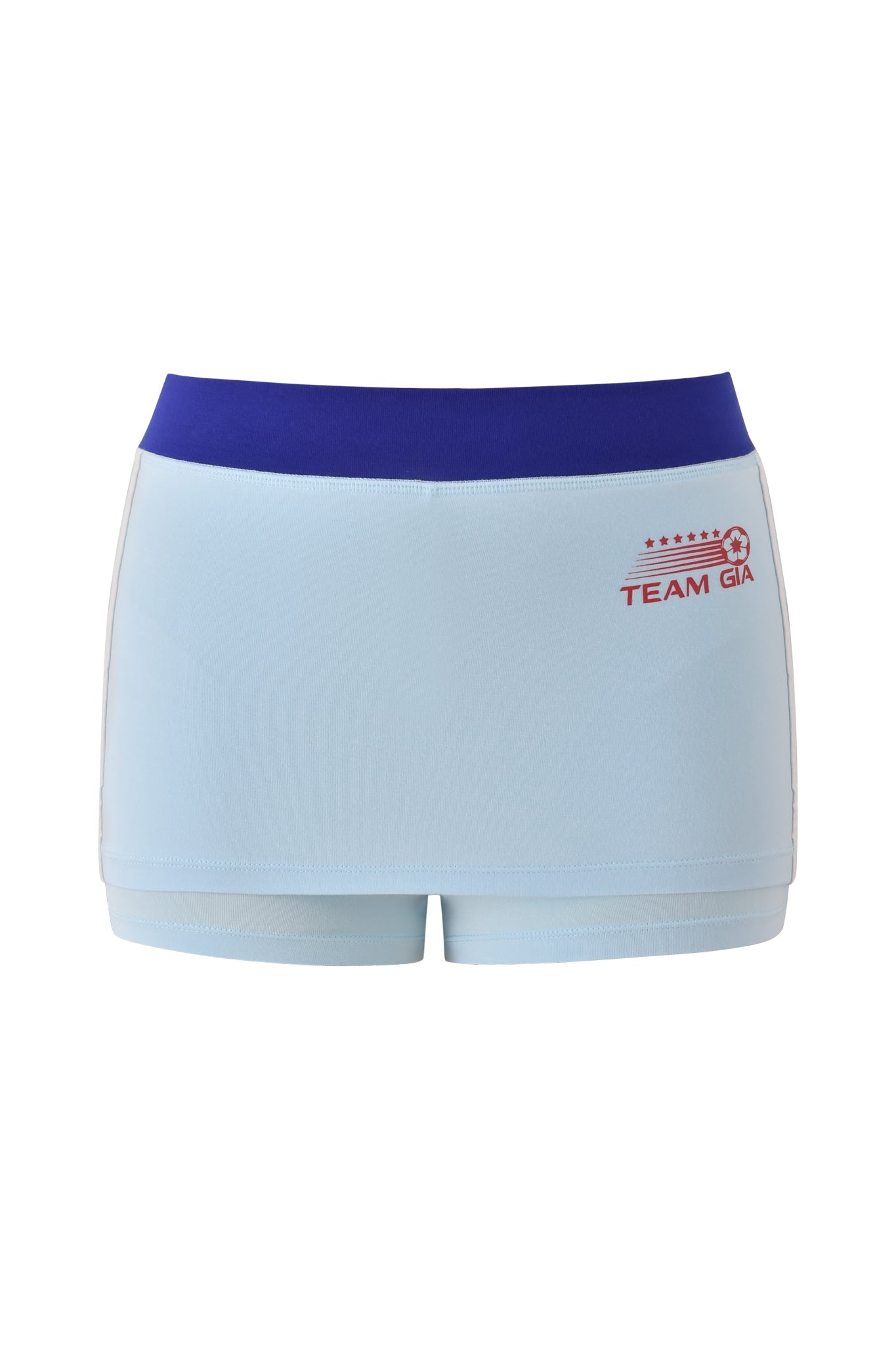 The BLARE VARSITY MICRO SKORT - BABY BLUE by I.AM.GIA is a light blue, sporty skort with a wide dark blue waistband and red "TEAM GIA" stars-and-stripes logo on the left, crafted from buttery-soft fabric and shown on a white background.