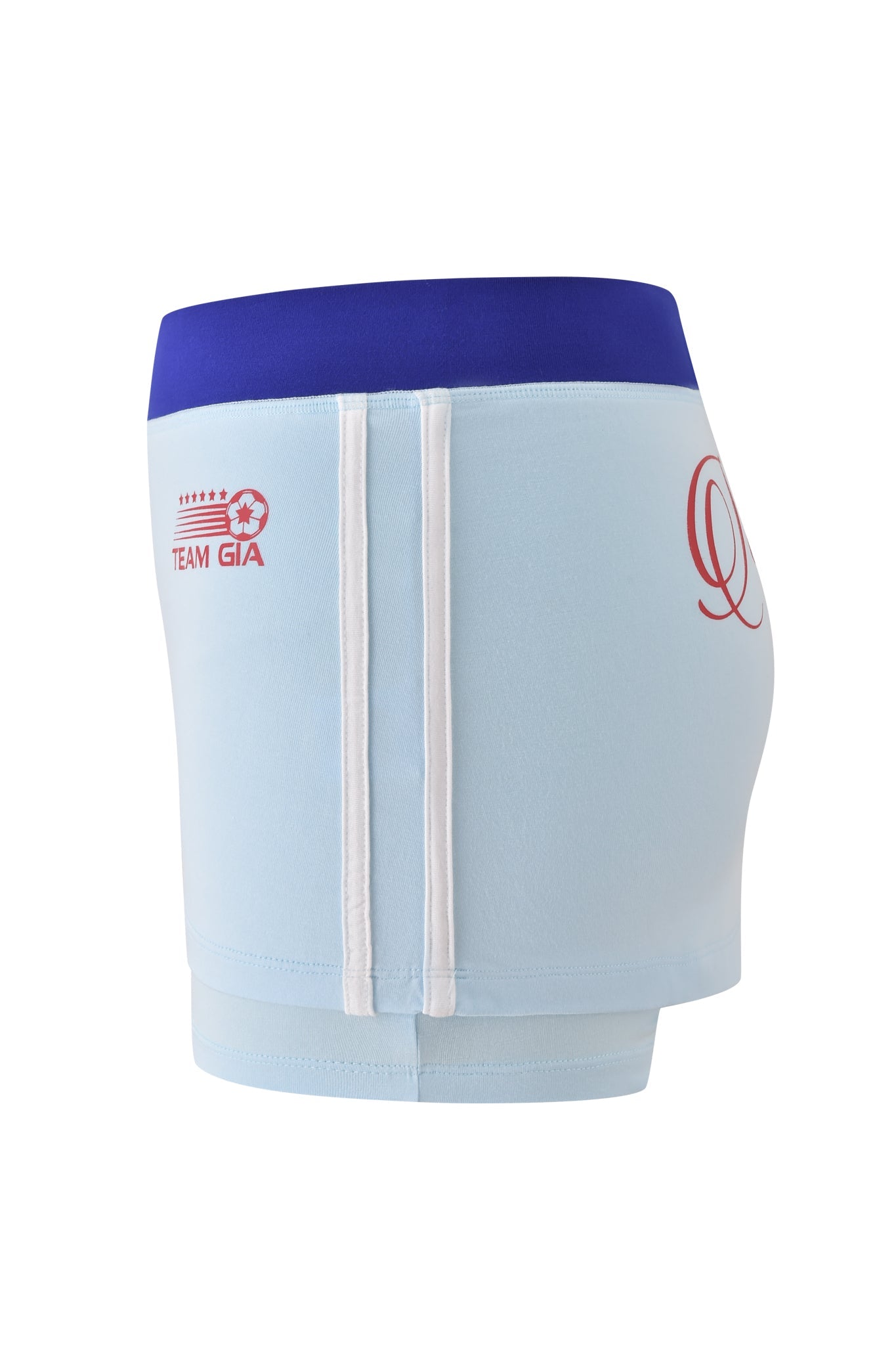 The BLARE VARSITY MICRO SKORT - BABY BLUE by I.AM.GIA is a sporty, buttery-soft micro skort with two vertical white stripes, a wide blue waistband, and red "TEAM GIA" text plus a soccer ball graphic near the waistband.