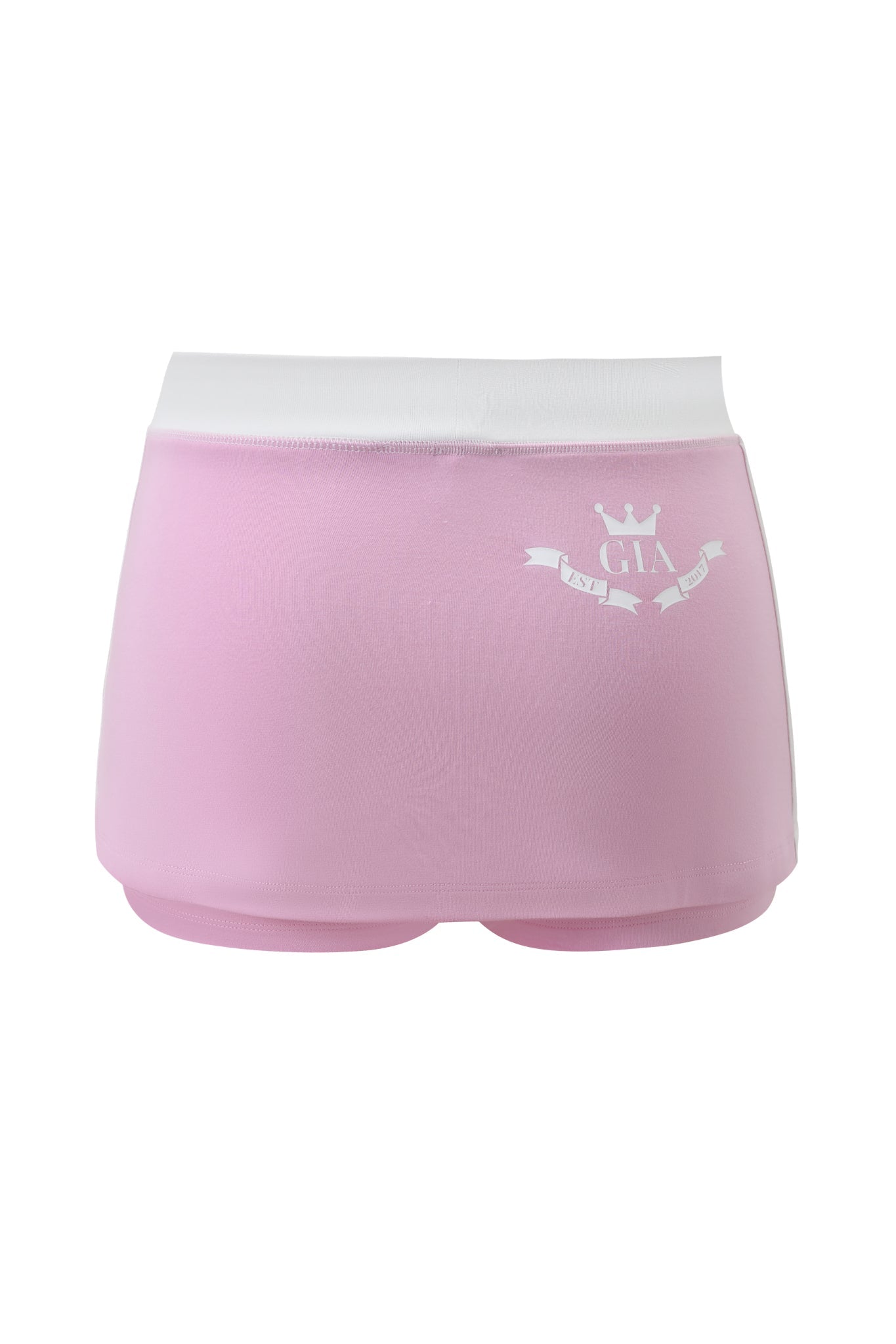 The BLARE PIPING MICRO SKORT by I.AM.GIA is a baby pink and white skort featuring a white waistband, a small white crown, and "GIA" printed on the back left above a decorative banner.