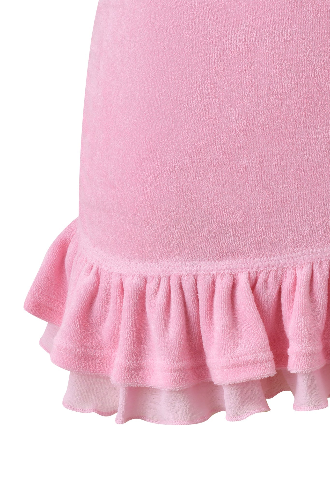 Close-up of the I.AM.GIA BRIELLE TERRY MINI SKIRT - PINK, featuring soft pink terry fabric, a double-layered ruffled hem, textured material, and detailed stitching.