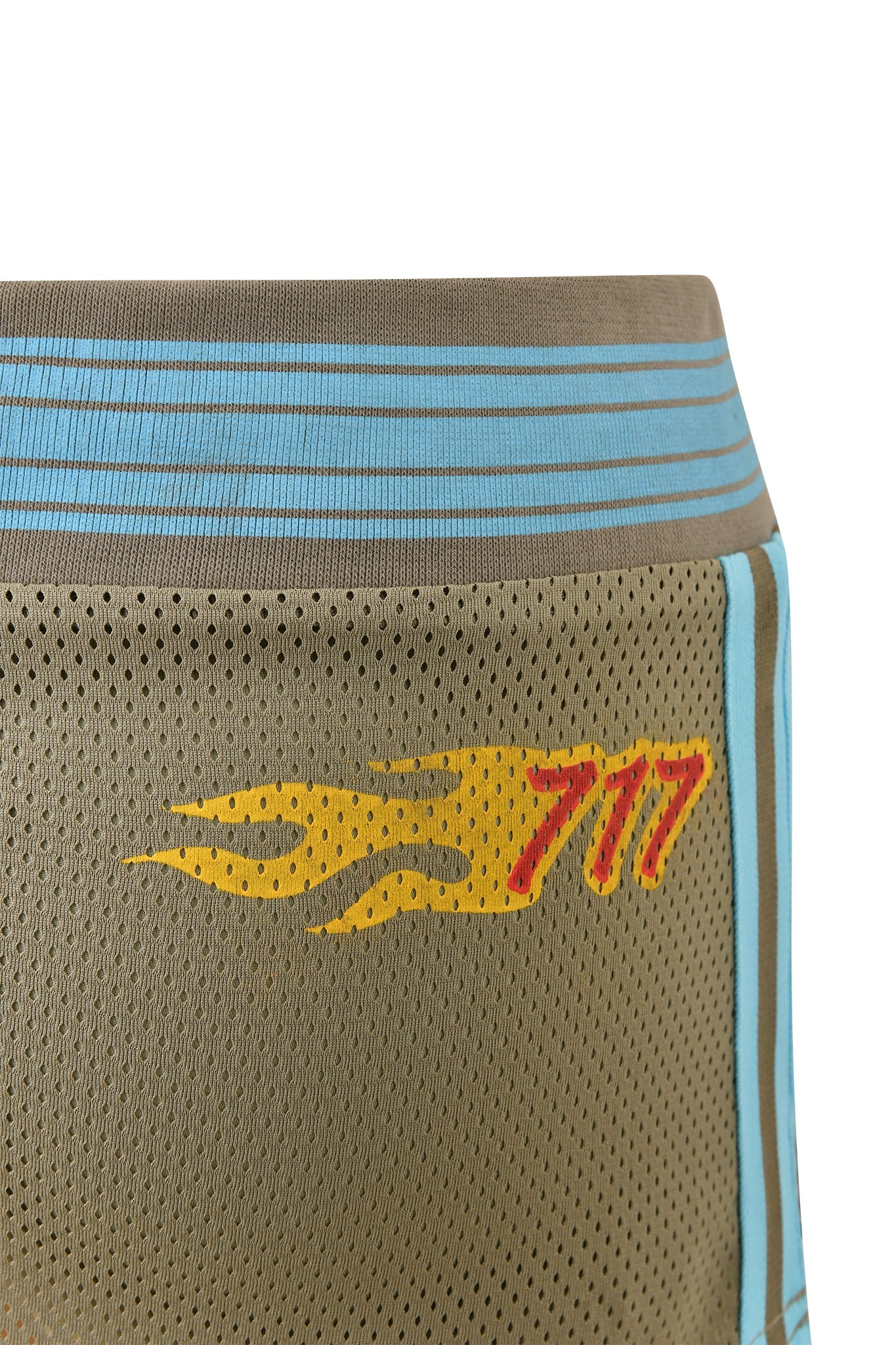 Close-up of the I.AM.GIA CHANDLER MINI SKORT - GREEN, featuring sport mesh fabric, light blue stripes, a yellow flame graphic, and a red "777" on the side.