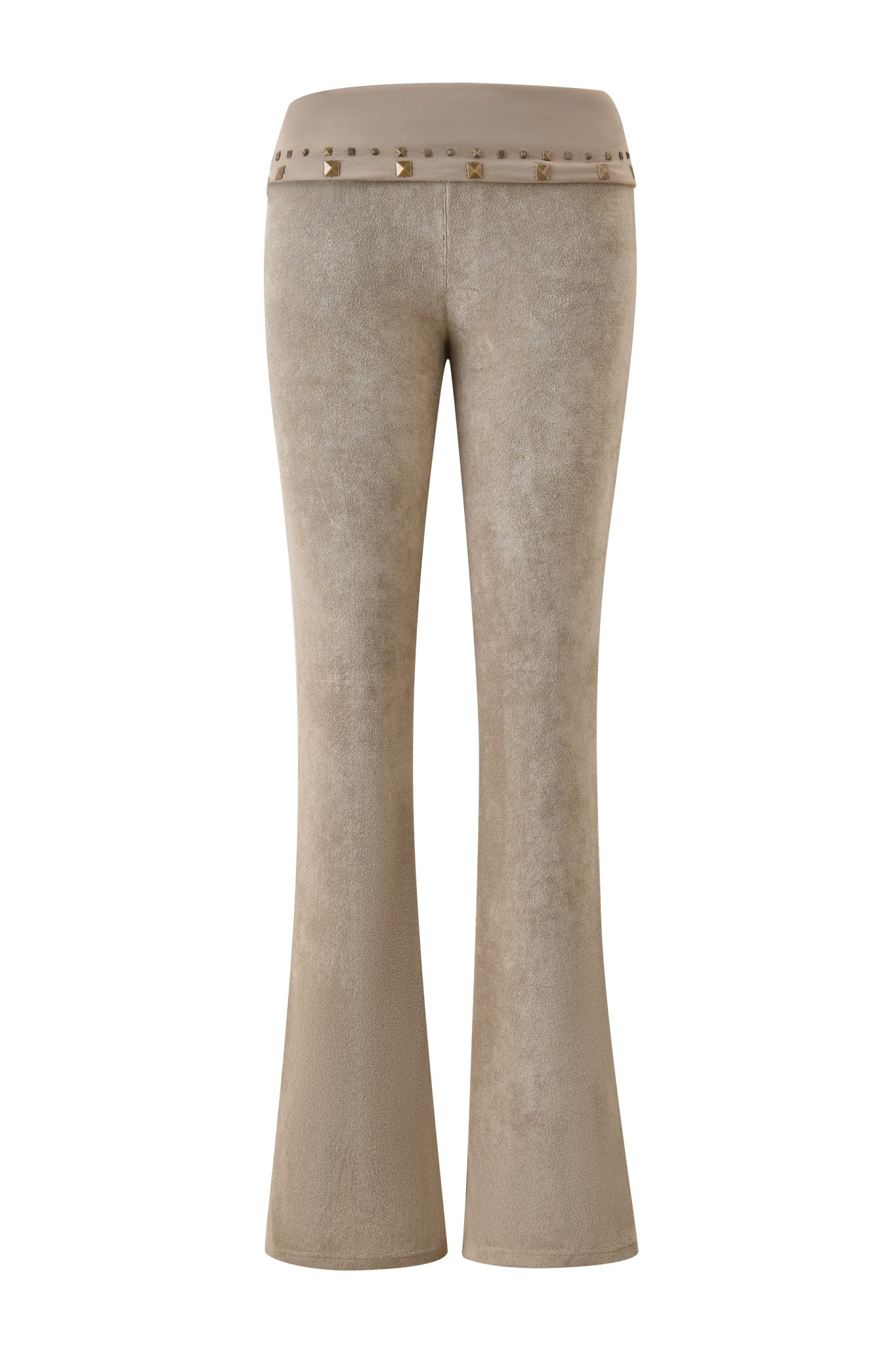 The BLARE STUDDED TERRY PANT - STONE by I.AM.GIA features high-waisted, flared legs and a wide waistband, all in beige terry fabric. Gold studs accent the waistband, evoking the brand’s iconic trackpant silhouette.