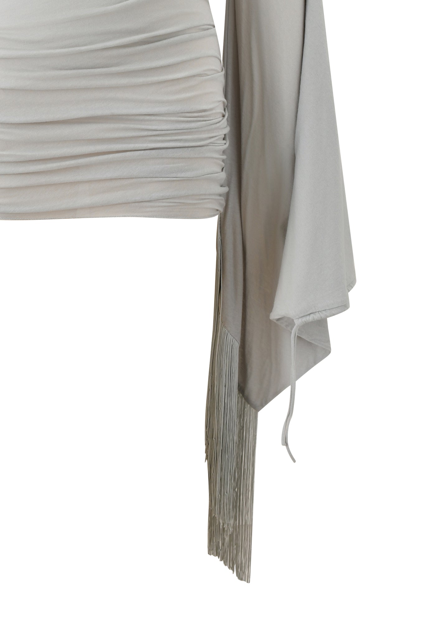 A cropped image of the LUMA MINI DRESS - GREY by I.AM.GIA, featuring light gray ruching and long, wide sleeves with cascading fringe details that add dynamic movement and decorative flair to the look.