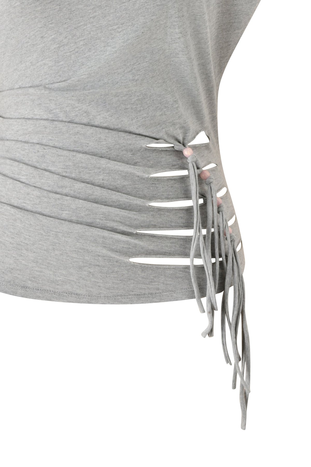 A close-up of the I.AM.GIA BEX OFF SHOULDER TOP in grey showcases side slits secured with matching fabric strips, forming a fringe detail along the seam. The asymmetric side cutout lends a modern edge to this off-the-shoulder jersey top.