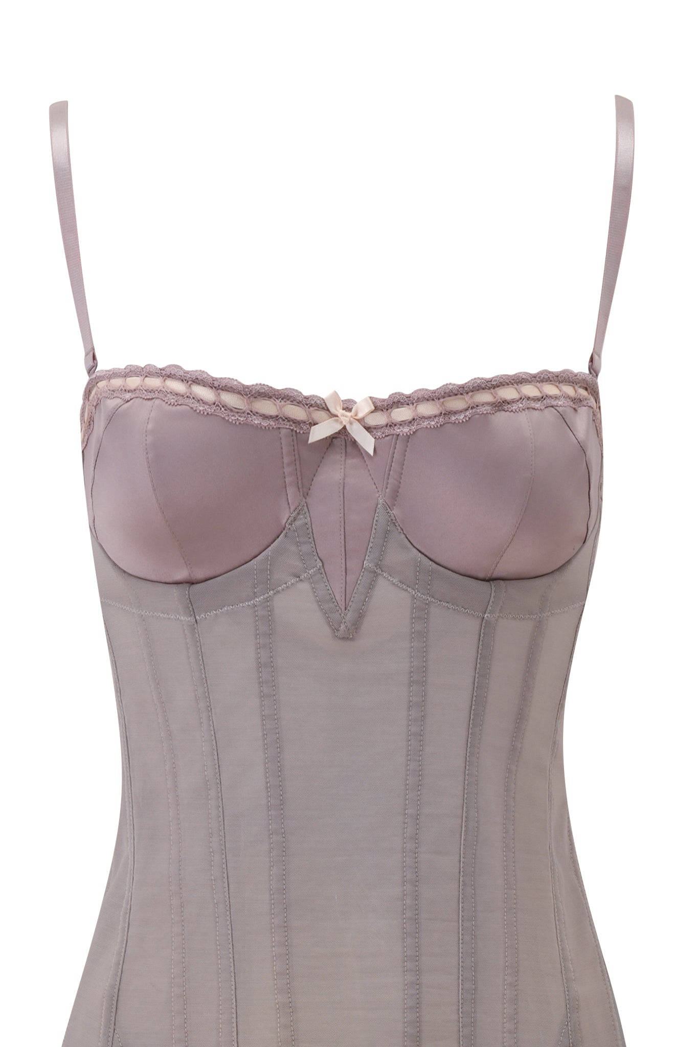 The ODETTE DRESS - DOVE by I.AM.GIA is a light mauve, corset-inspired dress with thin straps, padded cups, lace trim, vertical boning, and a delicate center bow for an elegant finish.